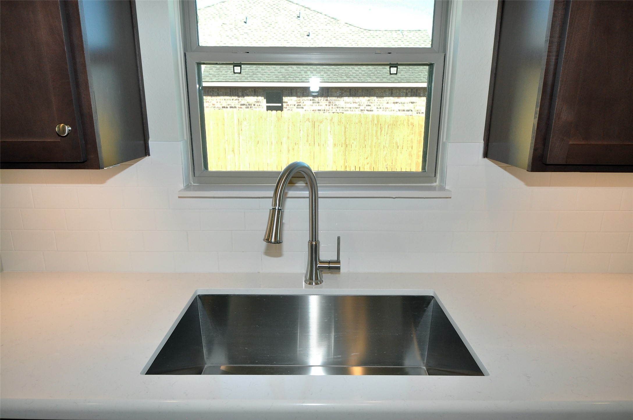 Undercounted SS sink has a large single bowl.