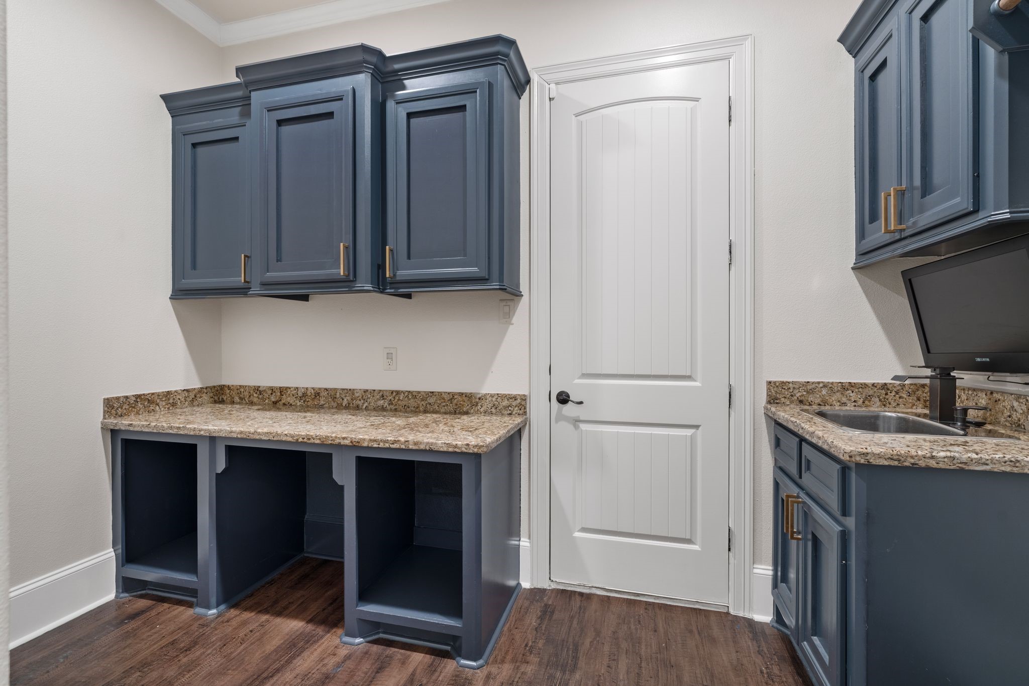 Laundry room with a folding table, sink and storage