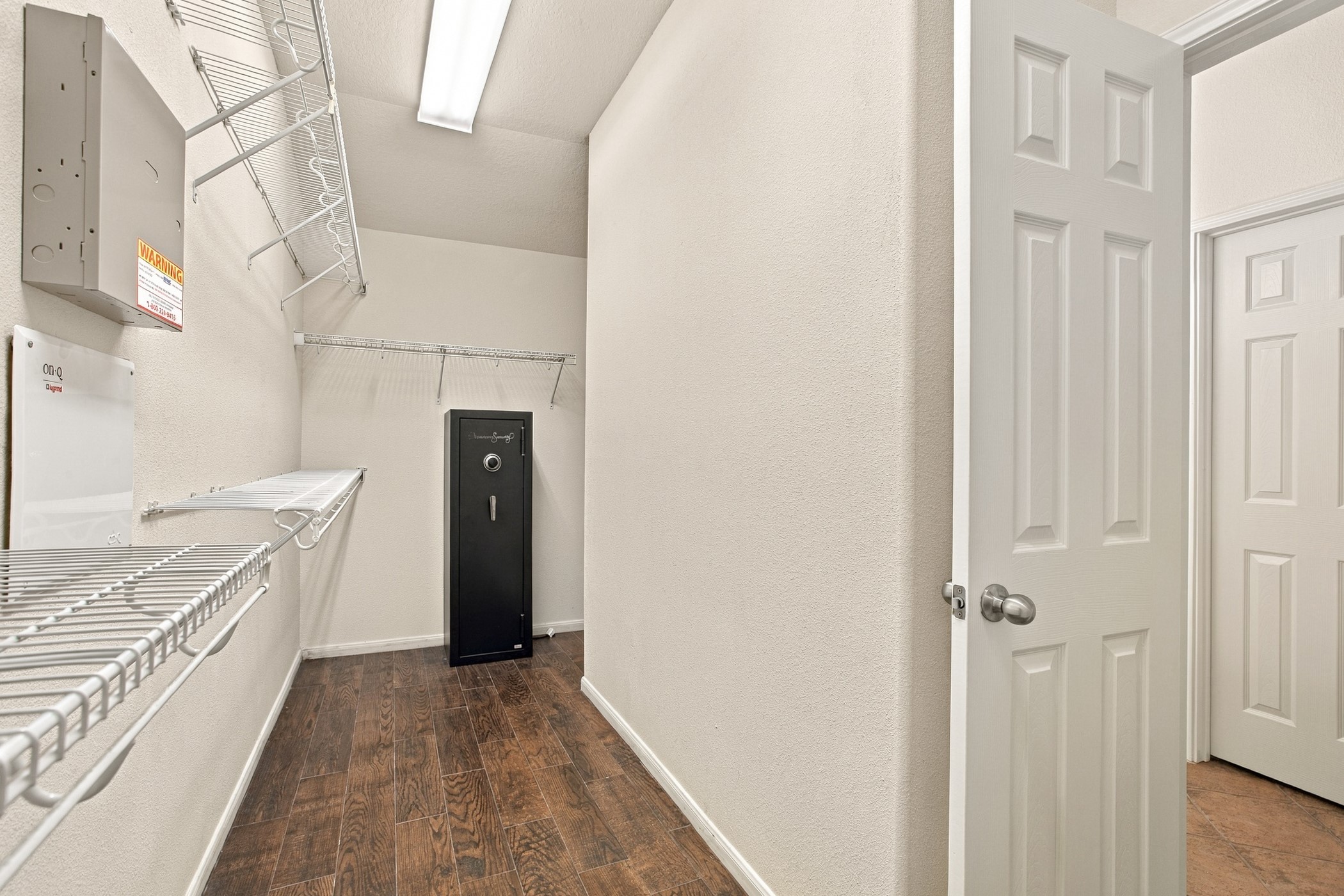 Walk in closet in primary bedroom with safe included