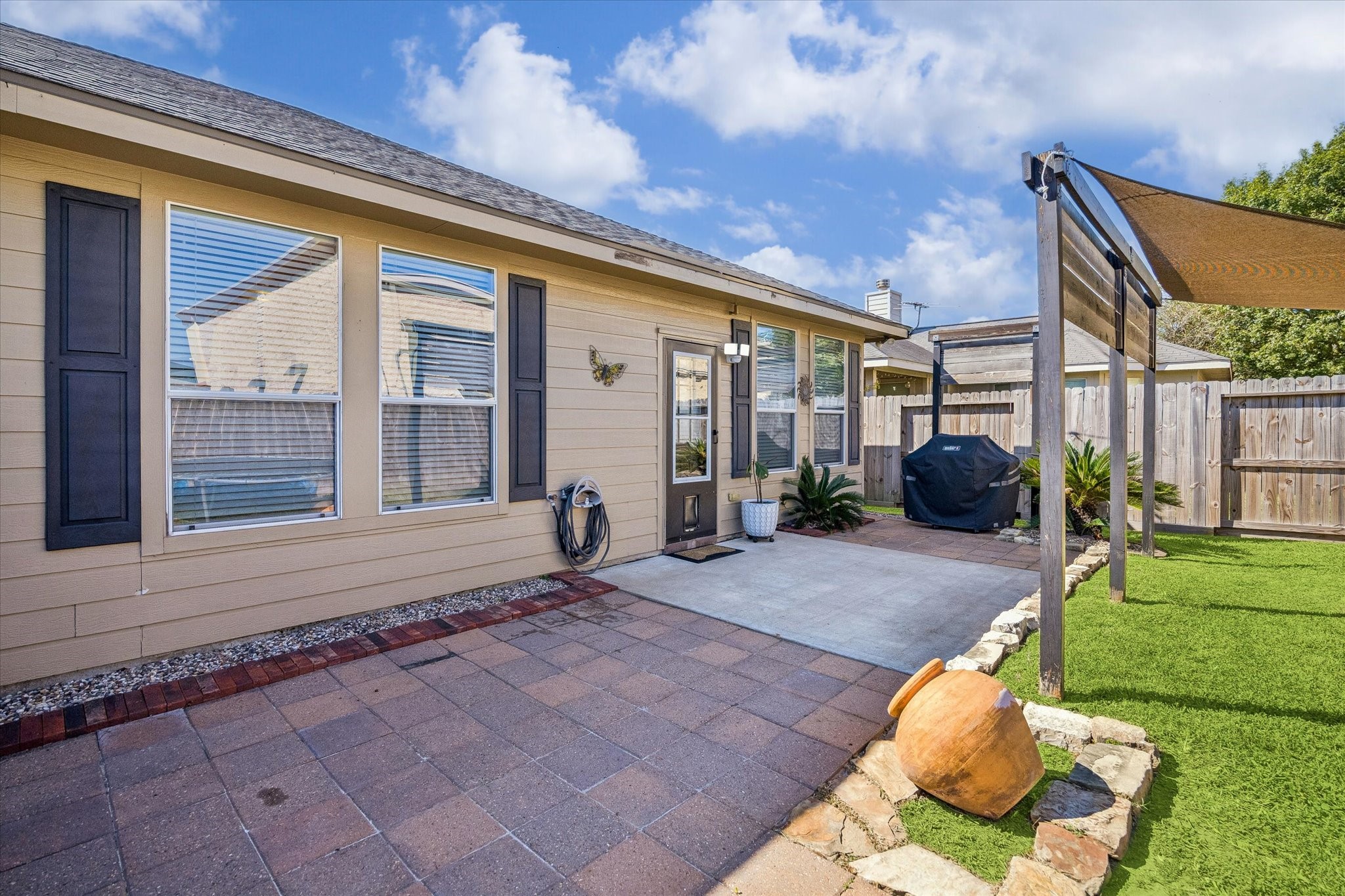 A generous patio extends the living space outdoors, offering room for seating, grilling, and entertaining. With easy access to the backyard and pergola, it's a great setup for weekend get-togethers or quiet evenings outside.