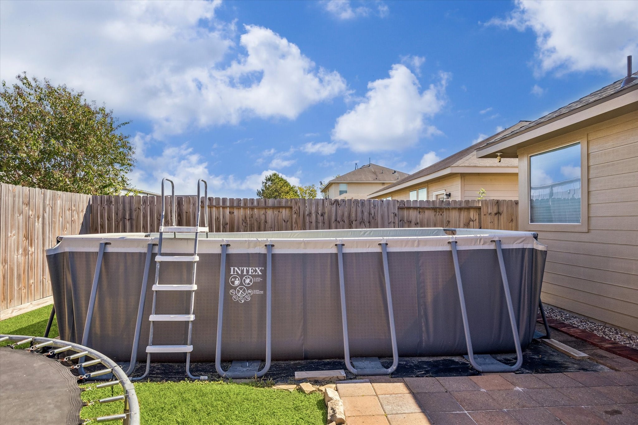 The backyard features an above-ground pool, perfect for cooling off during those warm Texas summers. A private fenced setting offers space to enjoy sunny afternoons at home.