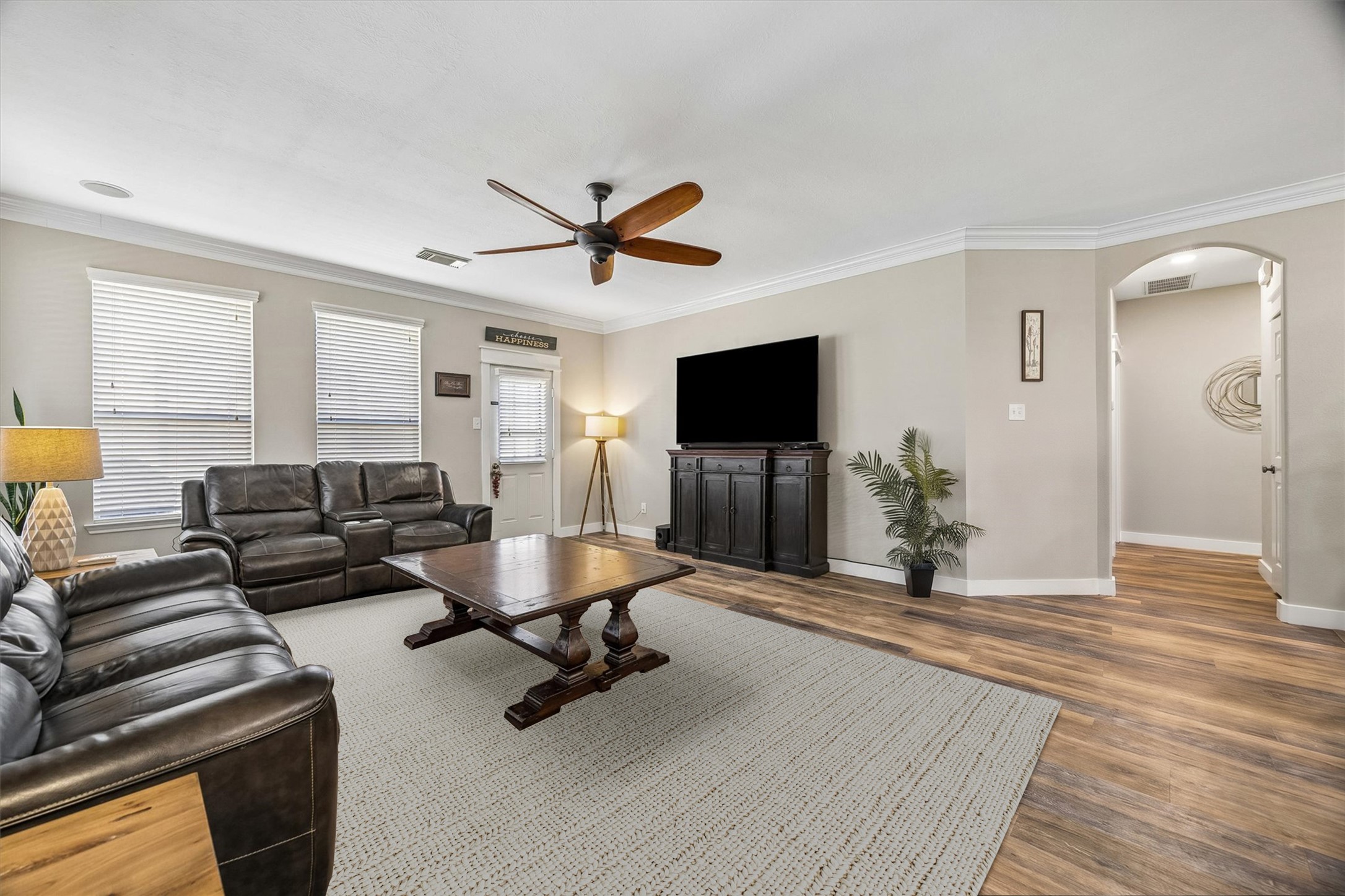 A bright and inviting family room with large windows, warm flooring, and a layout that makes furniture placement easy. Whether you're hosting friends or enjoying a quiet evening, this space feels right at home.