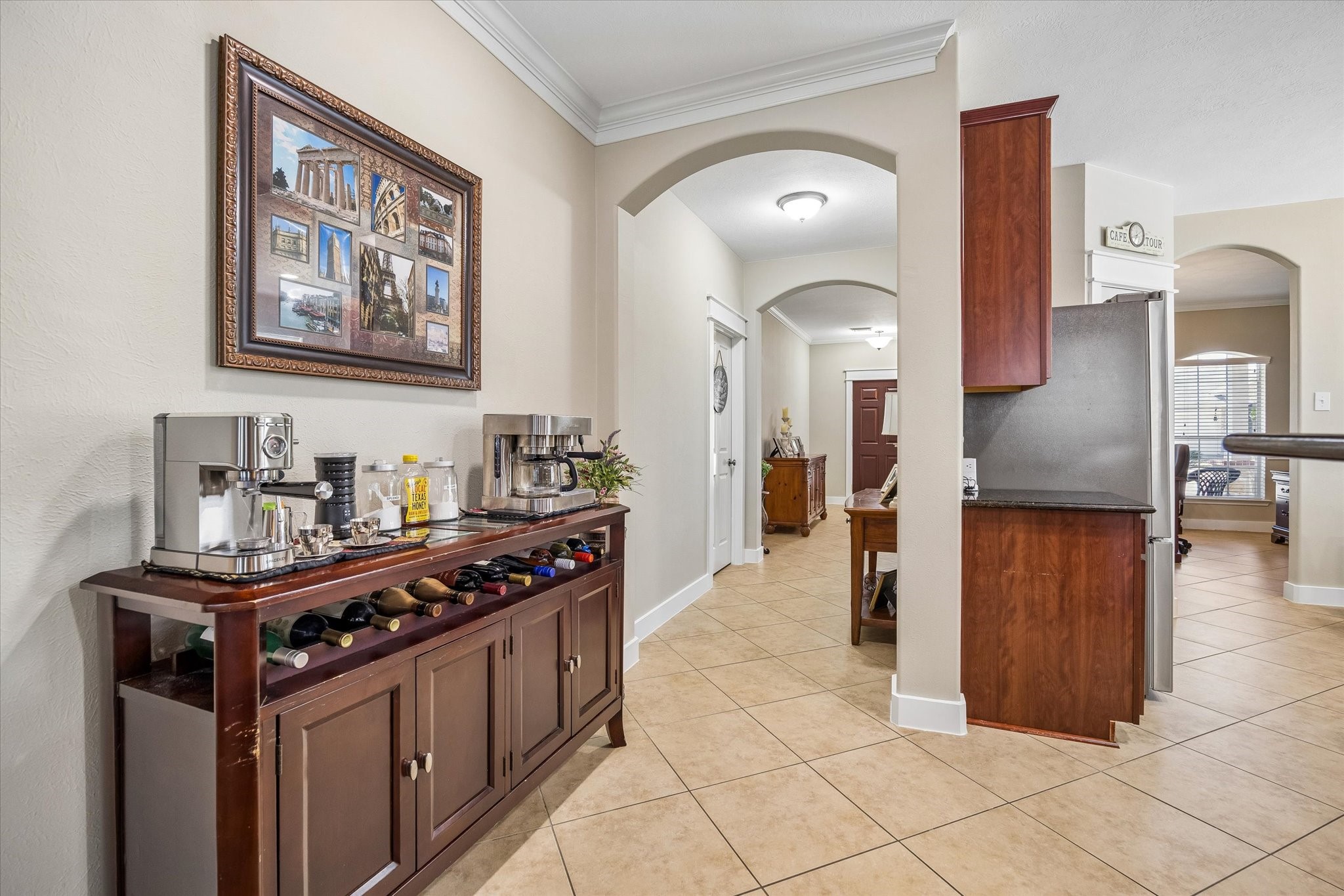 An elegant arched opening connects the dining area to the kitchen, creating a natural flow for everyday living and entertaining. The space offers room for a buffet or console table, perfect for serving guests or displaying favorite pieces.