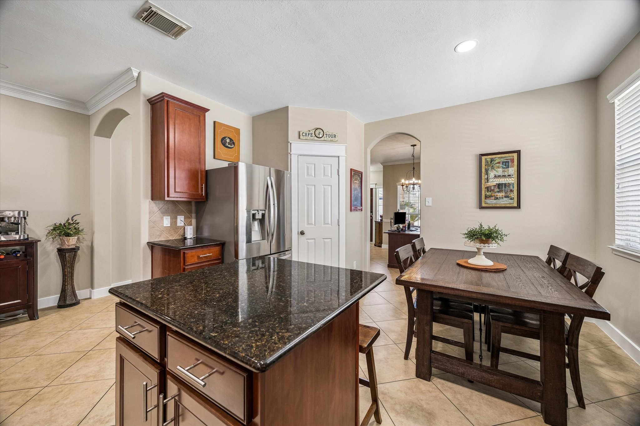 Another view of the kitchen highlights the generous counter space, center island, and open breakfast area. The layout keeps everything connected, whether you're cooking dinner or enjoying a quiet morning at home.