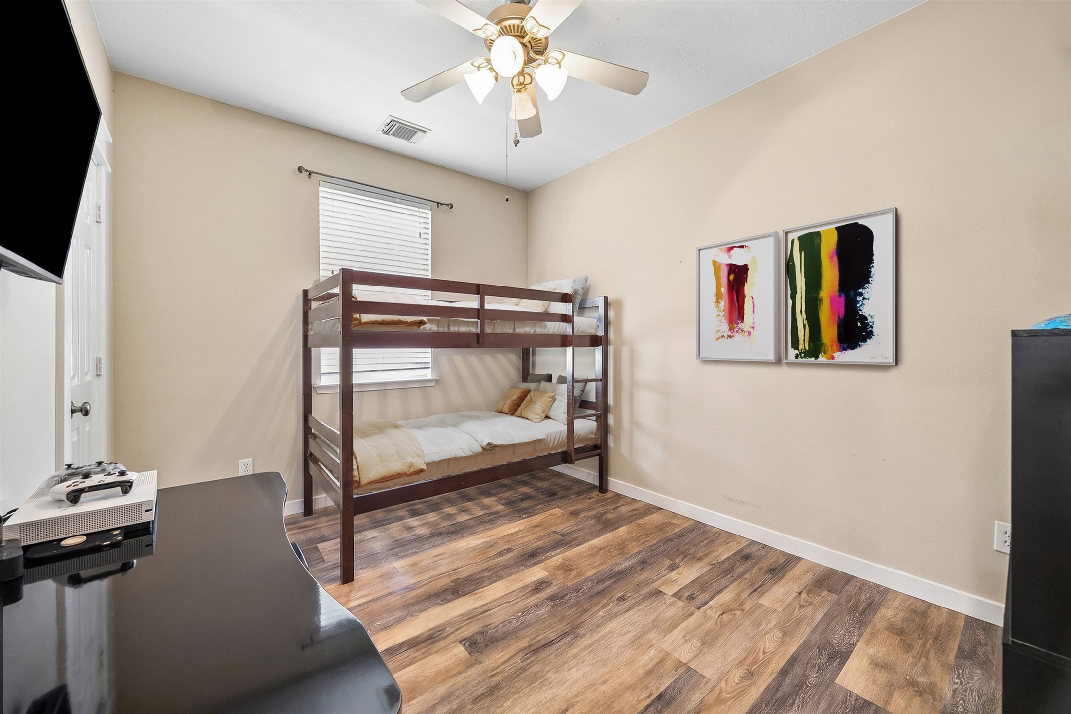 Another view of the secondary bedroom highlights its flexible layout and natural light. Whether used as a bedroom, playroom, or creative space, there's room to make it your own.