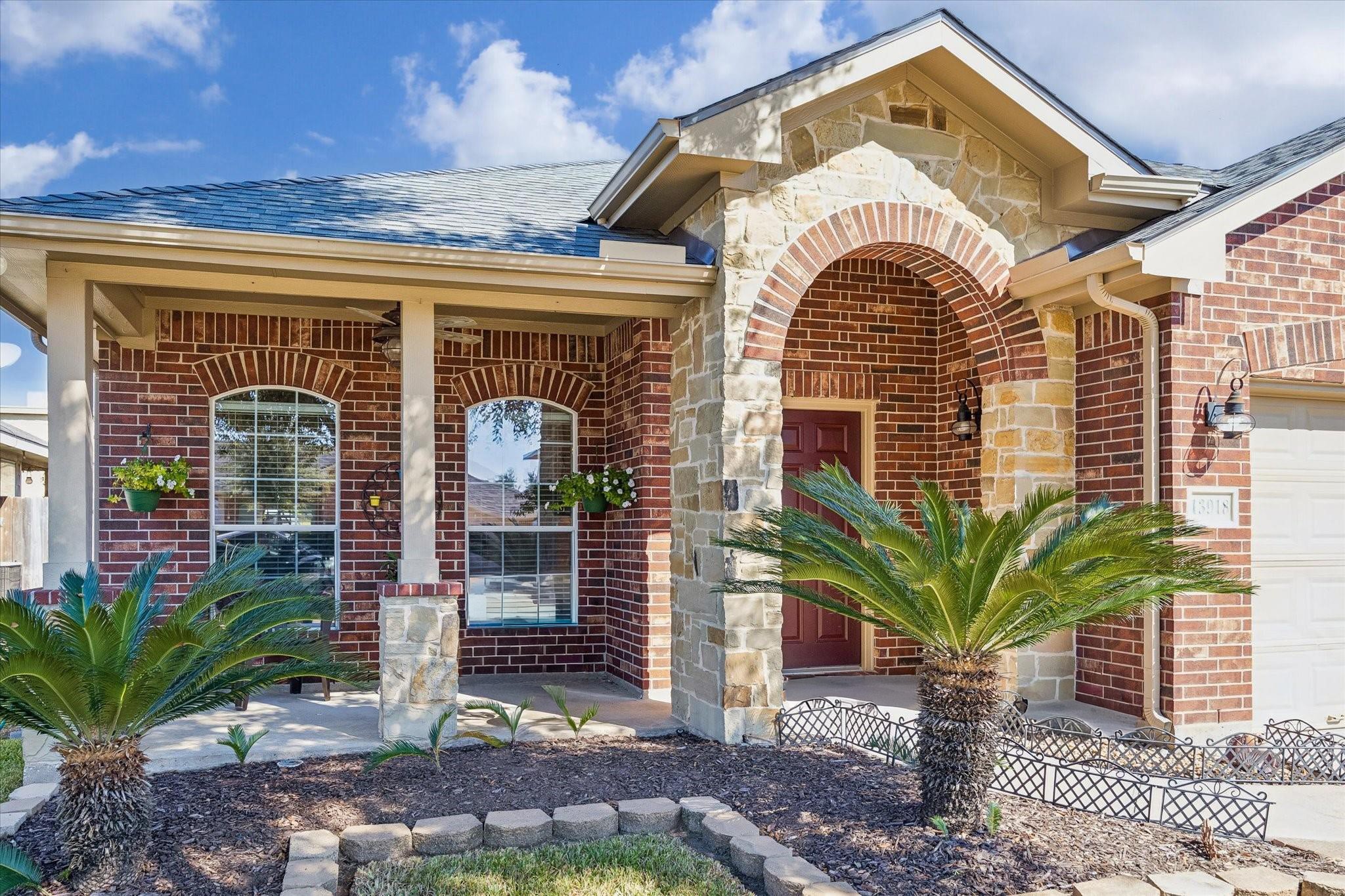 Brick-and-stone detailing, an arched entry, and thoughtfully maintained landscaping give this home plenty of character. A welcoming introduction to the comfortable, single-story living found inside.
