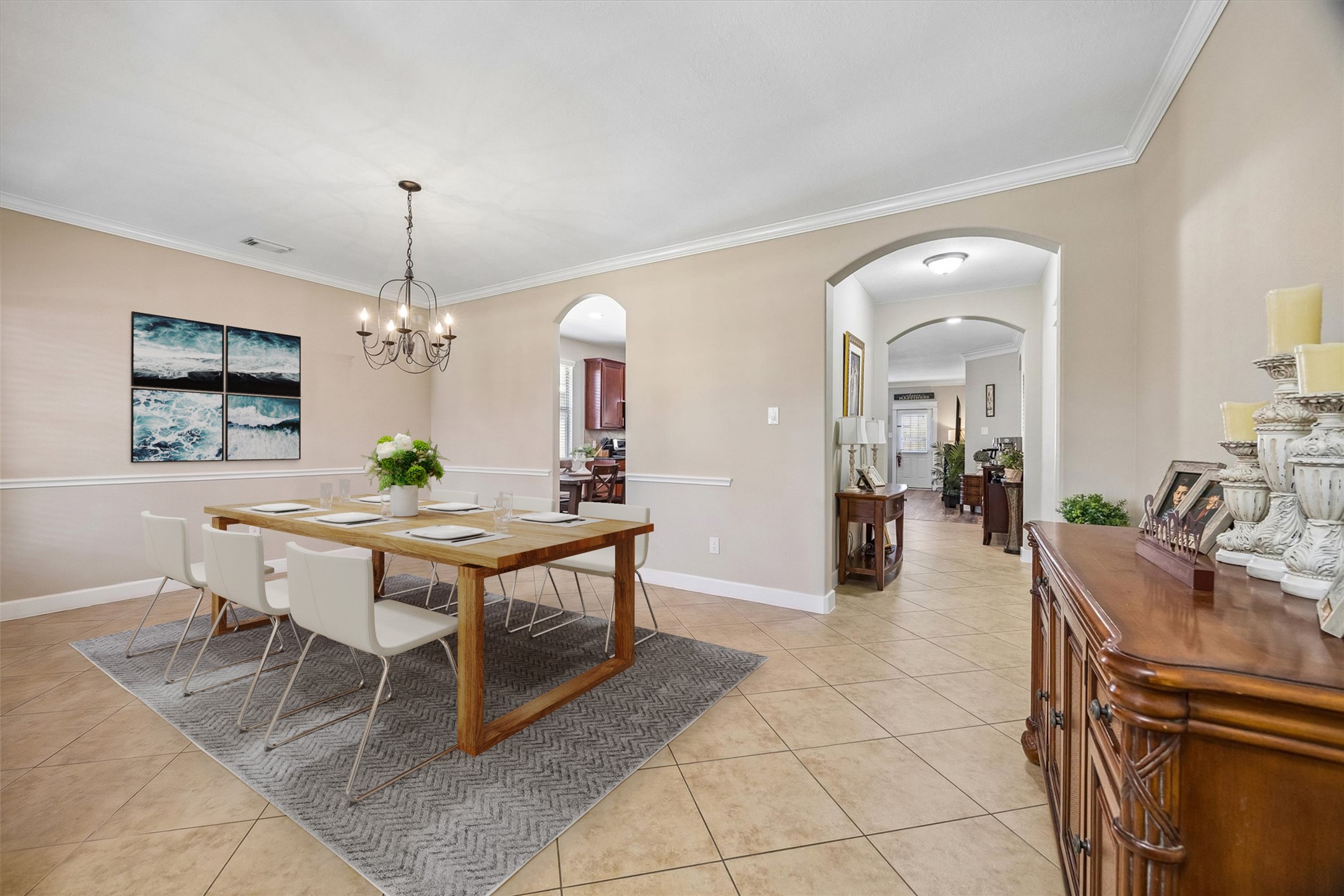 The formal dining room offers generous space for hosting family dinners and special occasions, with a beautiful chandelier and an open connection to the living area. Natural light and neutral finishes make the space feel warm and inviting.