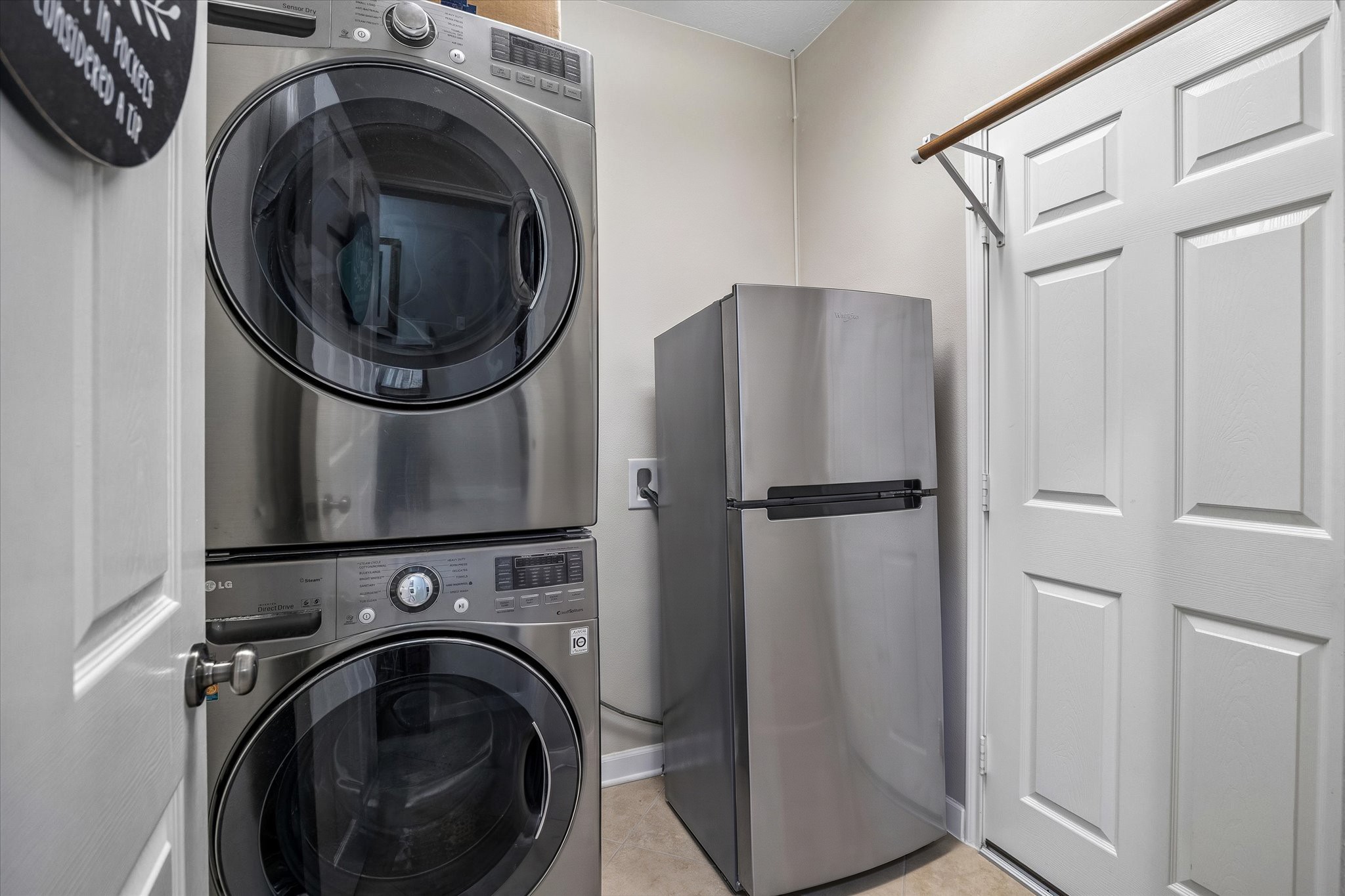 A dedicated utility room with space for a full-size washer and dryer makes laundry day a little easier. Additional storage keeps everyday essentials organized and out of sight.