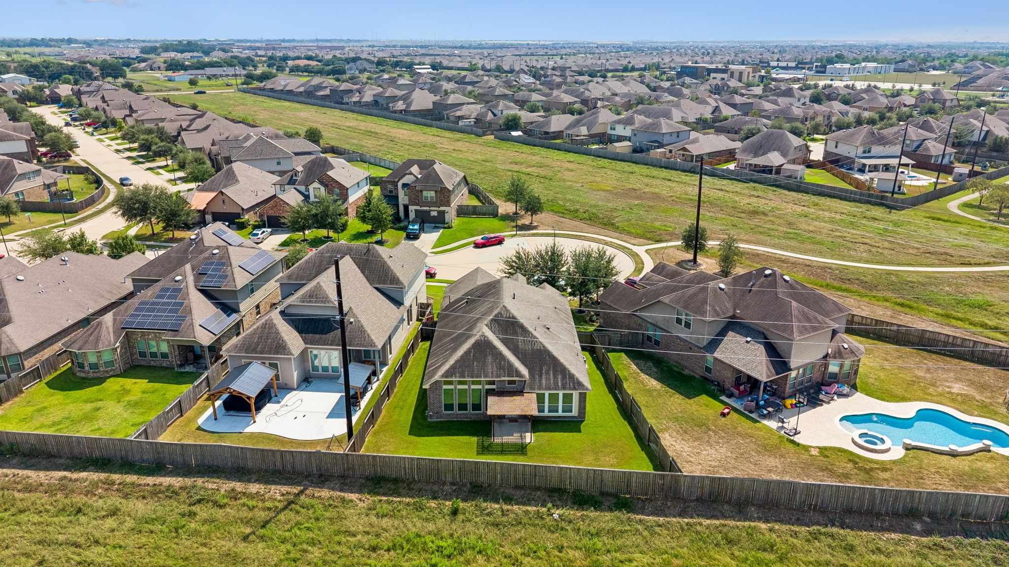 Aerial view of a charming cul-de-sac neighborhood featuring spacious backyards, against a lush greenbelt for added privacy of no back neighbors on a private street.