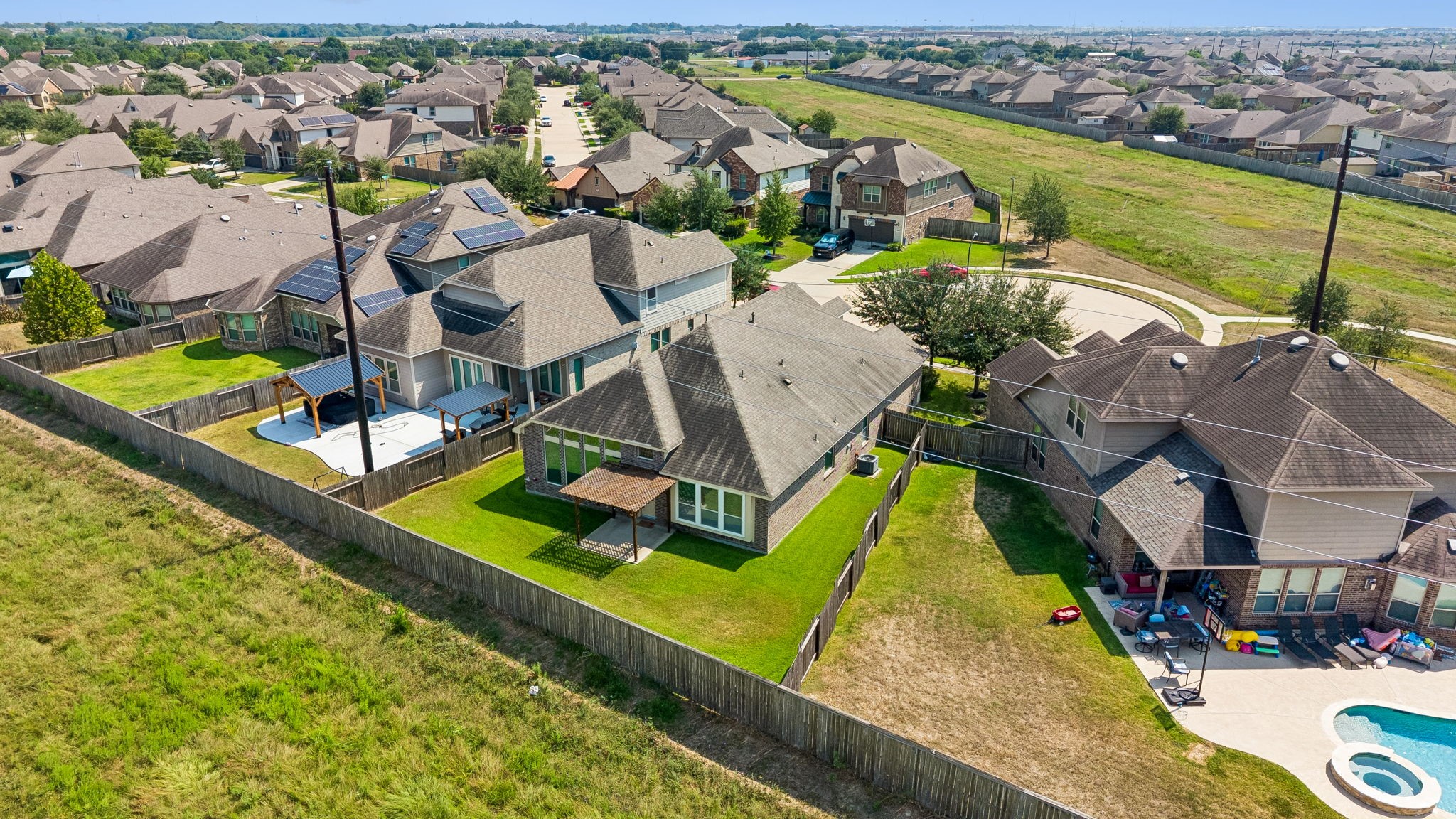 Aerial view of a charming cul-de-sac neighborhood featuring spacious backyards, against a lush greenbelt for added privacy of no back neighbors on a private street.