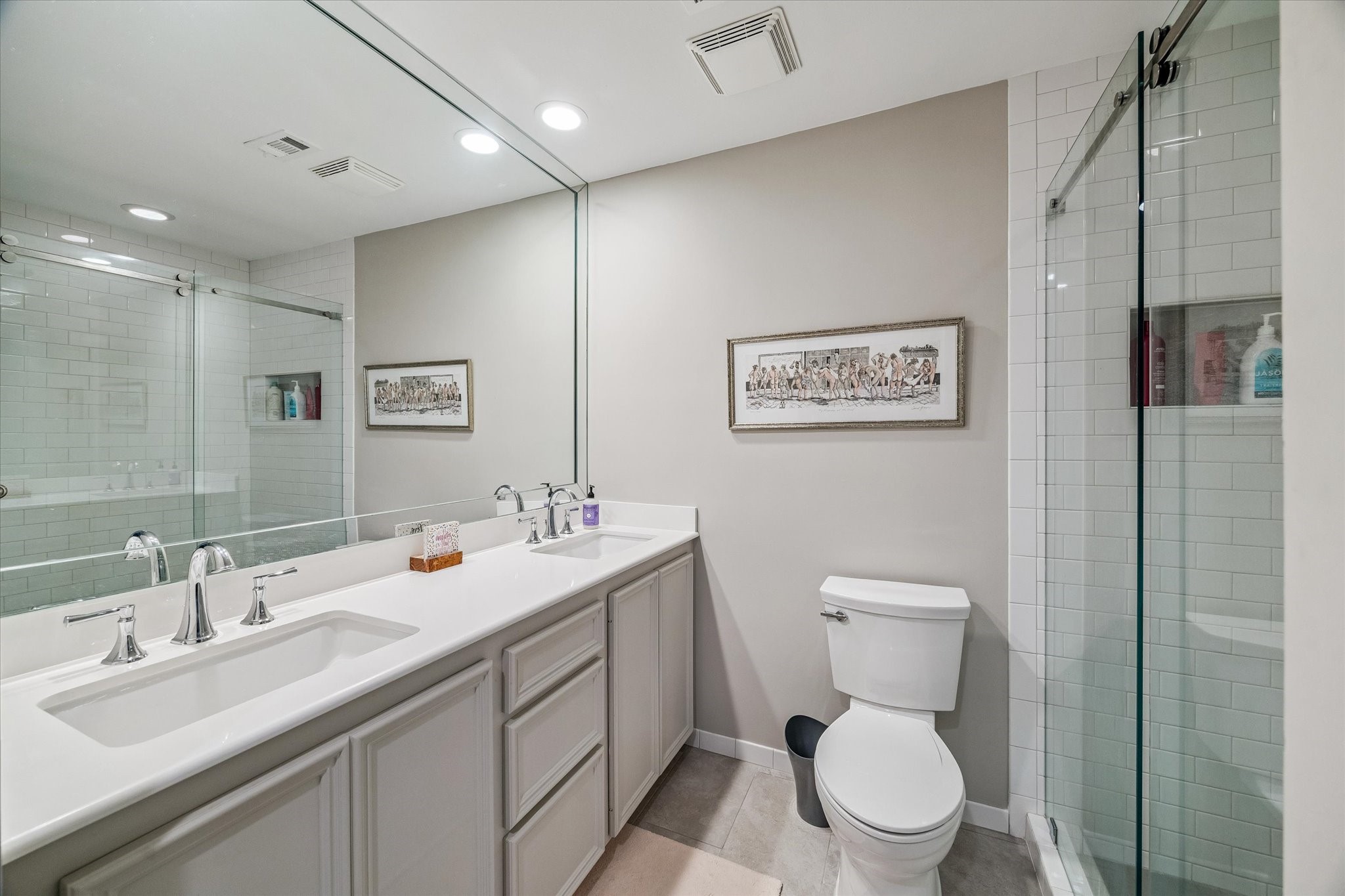 Spacious Primary Bath boasts dual undermounted sinks, marble counters and full length framed mirror, large frameless glass shower with timeless subway tile, worlds of built-in storage, large walk-in closet and more! Ahhh!