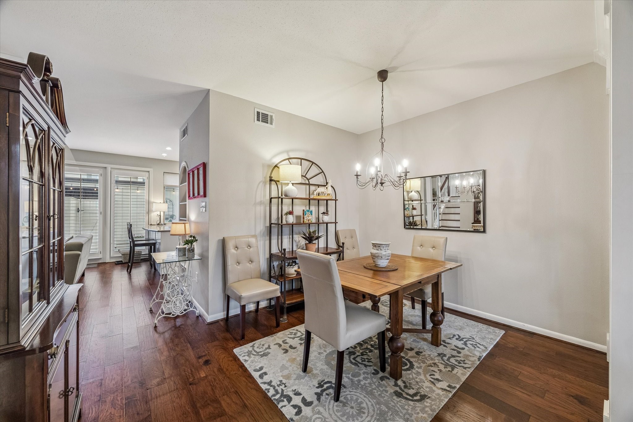 Your new formal Dining Room boasts an open space created by the expanded arched way, thus allowing for any size dining arrangements - large or small! Beaming beautiful wood floors, crisp floor and shoe molding, designer pewter 6 candle chandelier, high ceilings and be sure you check out the wonderful Bar area - ideal for entertaining!