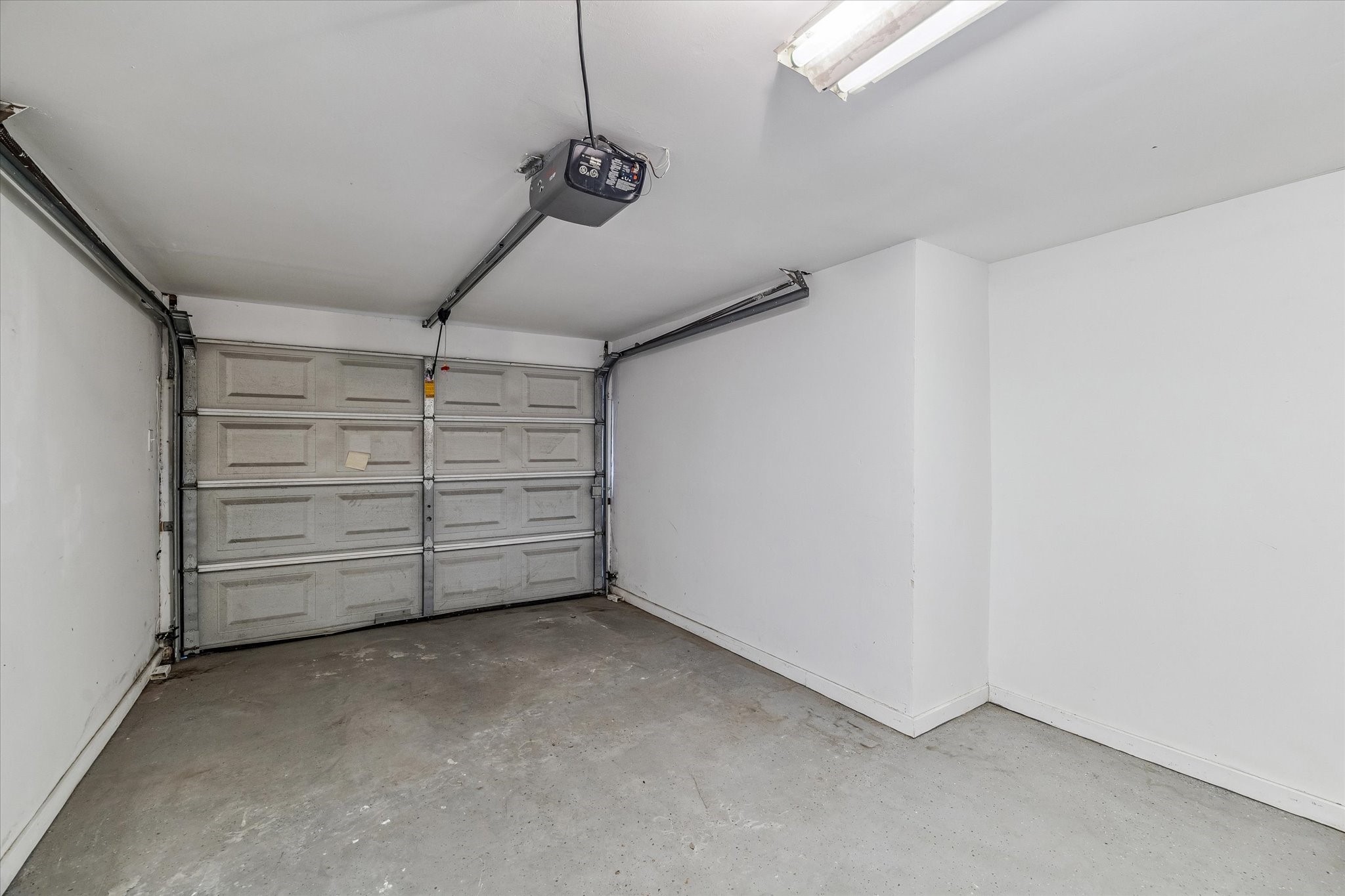 One of the 2 covered garages which is extremely rare in Tanglegrove, as the Seller has converted the carport to a second garage! This one is full drywalled with sheetrock & boasts a wall of storage shelving and the extra extra space you need! NICE!