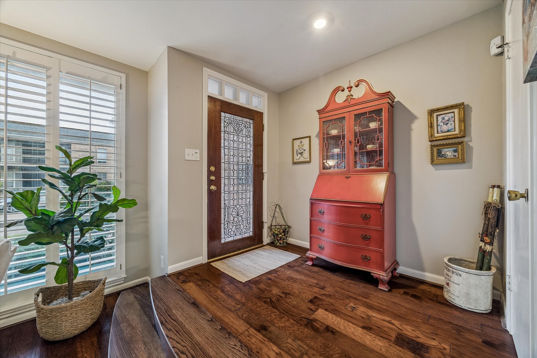 The spacious Entry allows you to view a sample of the remodeled interior with elegant wide plank wood floors, double pane windows w/ plantation shutters, stylish sparkling glass and wood front door and an inviting open flowing floorplan! NATURAL LIGHT GALORE!