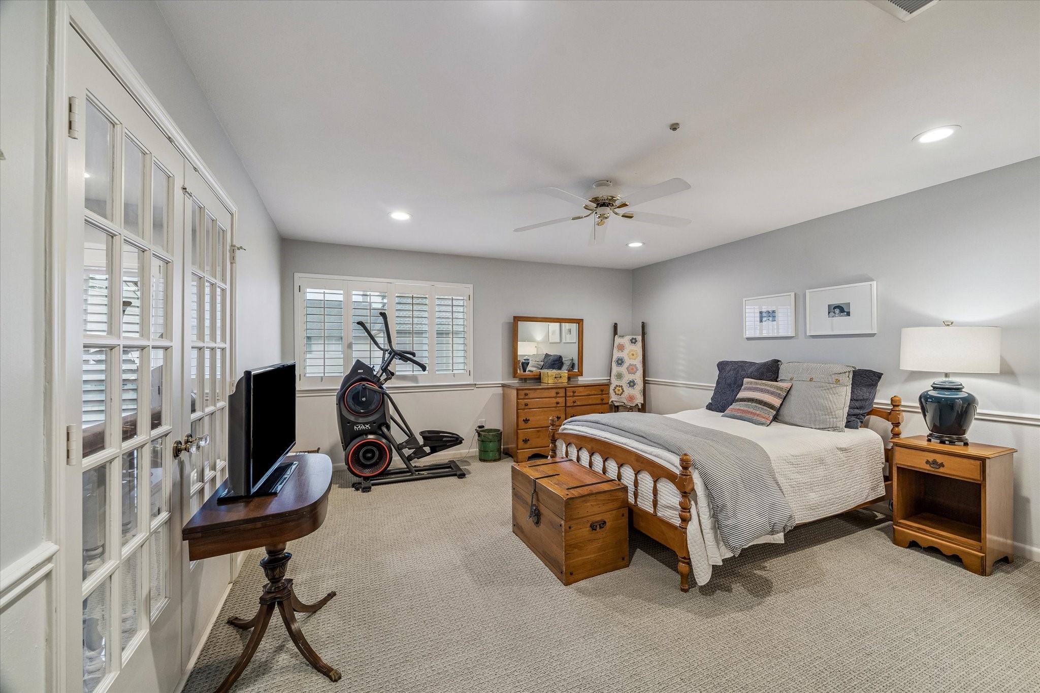 Spacious Guest Bedroom boasts clever French doors that open as a coveted loft space if desired which make it also ideal for creating a Home Office or Fitness area! NOTE the designer loop carpeting, LED recessed lighting, chair rail molding, custom plantation shutters, ceiling fan and in-suite privacy bath! STYLISH & WONDERFUL!