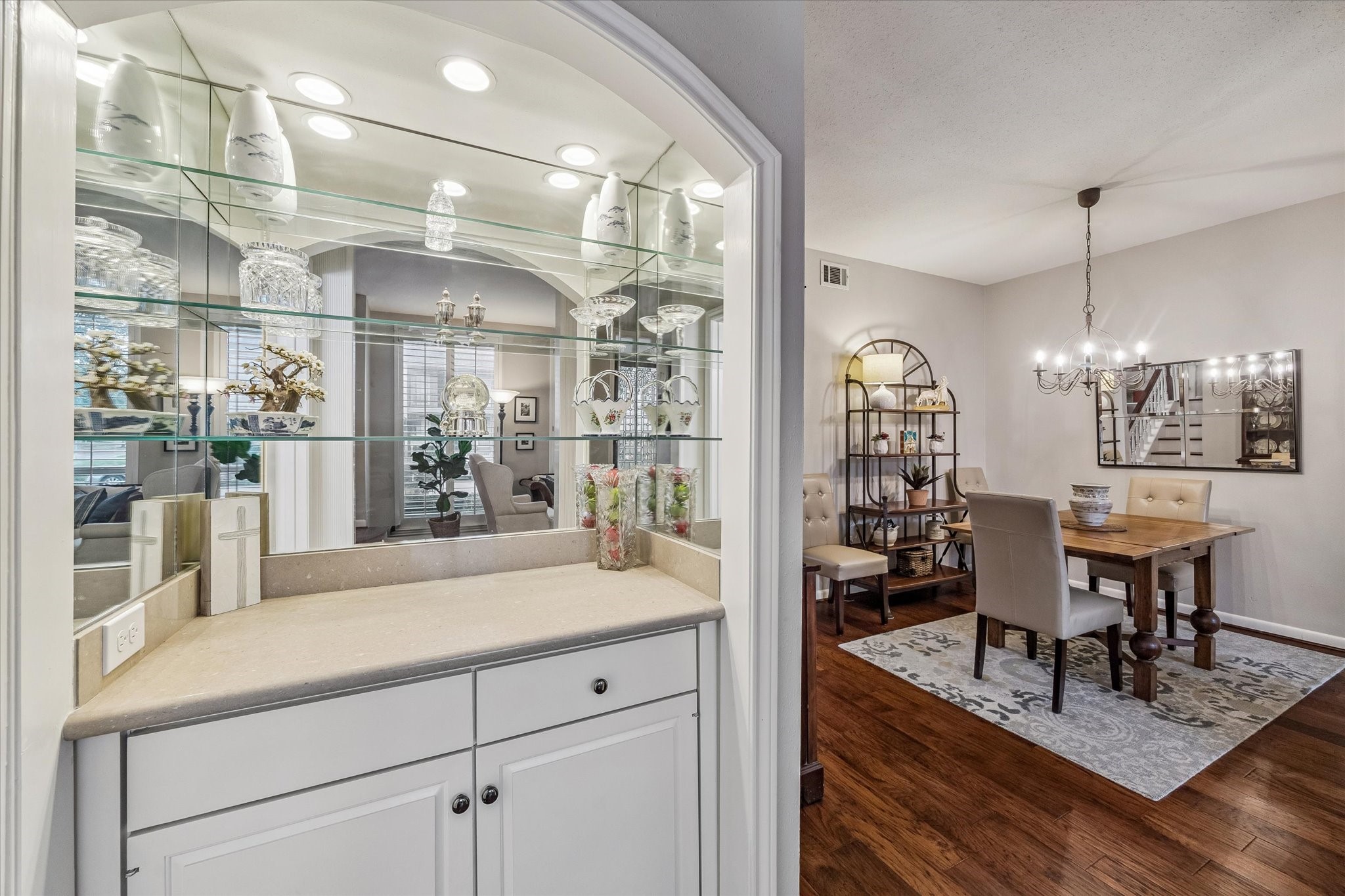 Elegant Bar off the Dining/Living Rooms boasts a marble counter, mirrored glass shelving, recessed lighting, great storage and more!