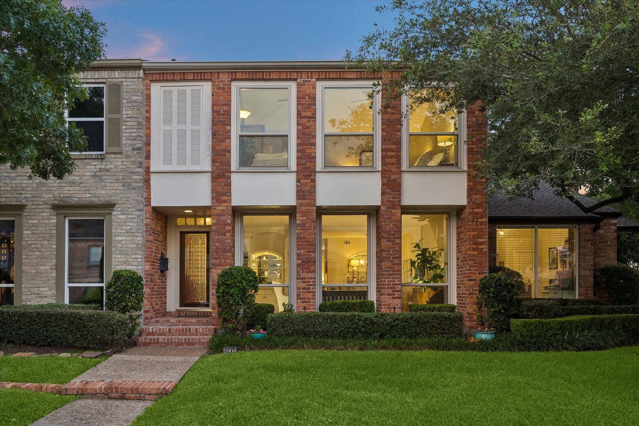 Stylish curb appeal boasting beautiful full length windows, handsome brick, a lush green yard with manicured flower beds, towering Oak trees and more! Stylish curb appeal boasting beautiful full length windows, handsome brick, a lush green yard with manicured flower beds, towering Oak trees and more!