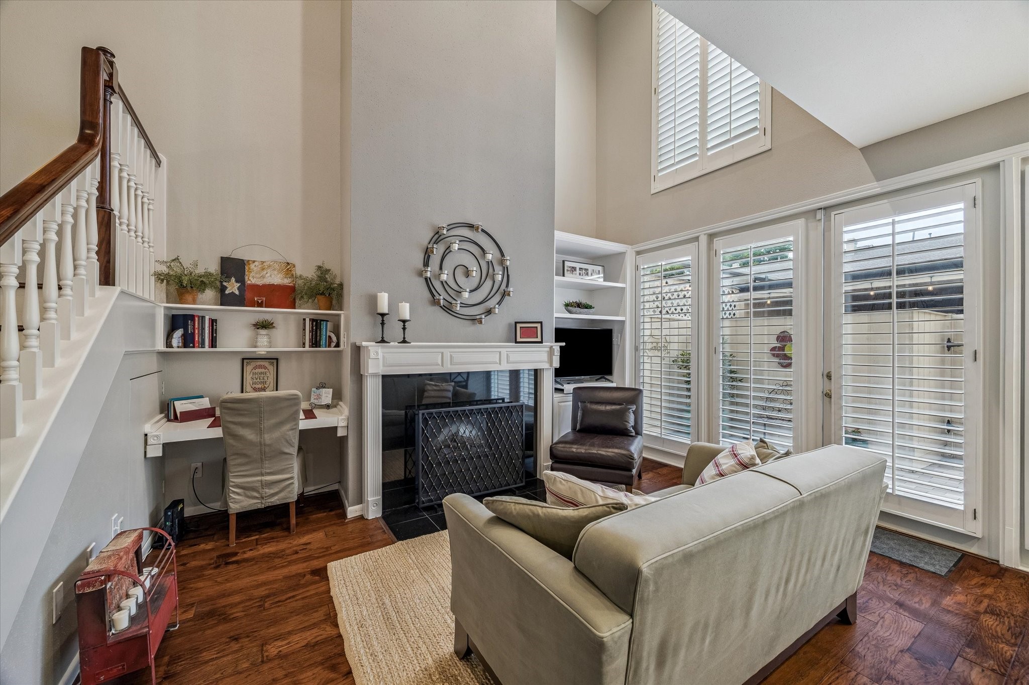Do you like natural light? If so, you'll absolutely love this Home! The Den/Family Rm boasts a coveted open flow to the brilliant Kitchen, while full length double pane windows with custom plantation shutters offer endless natural light and views of your private fenced patio! Note the built-in desk area, under-stair storage, recessed lights, wide plank wood floors, custom wood painted mantle gas/wood fireplace & more! OUTSTANDING!