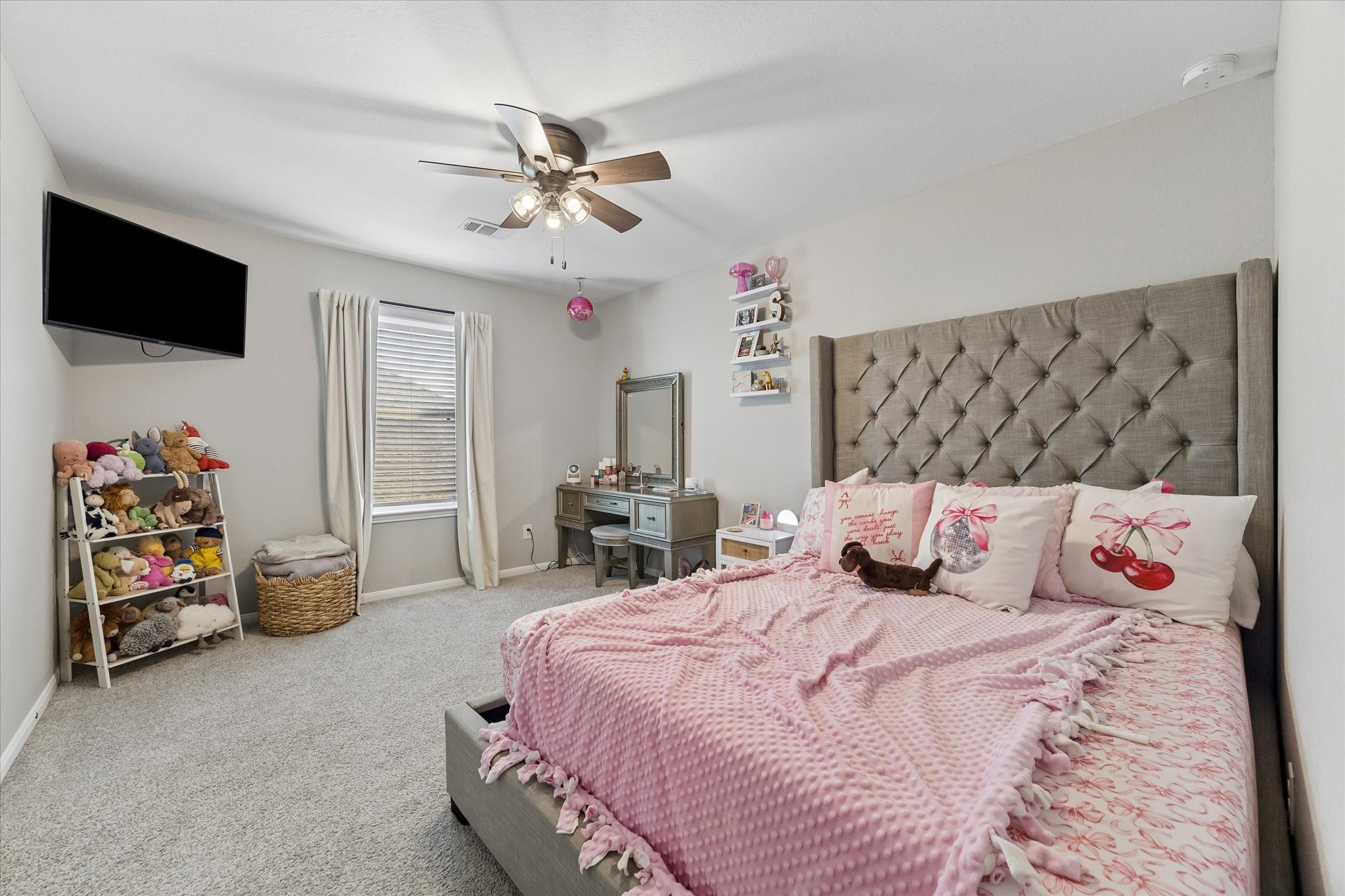 A huge walk-in closet adds standout storage to this upstairs secondary bedroom, with ample room for clothing, shoes, and more.