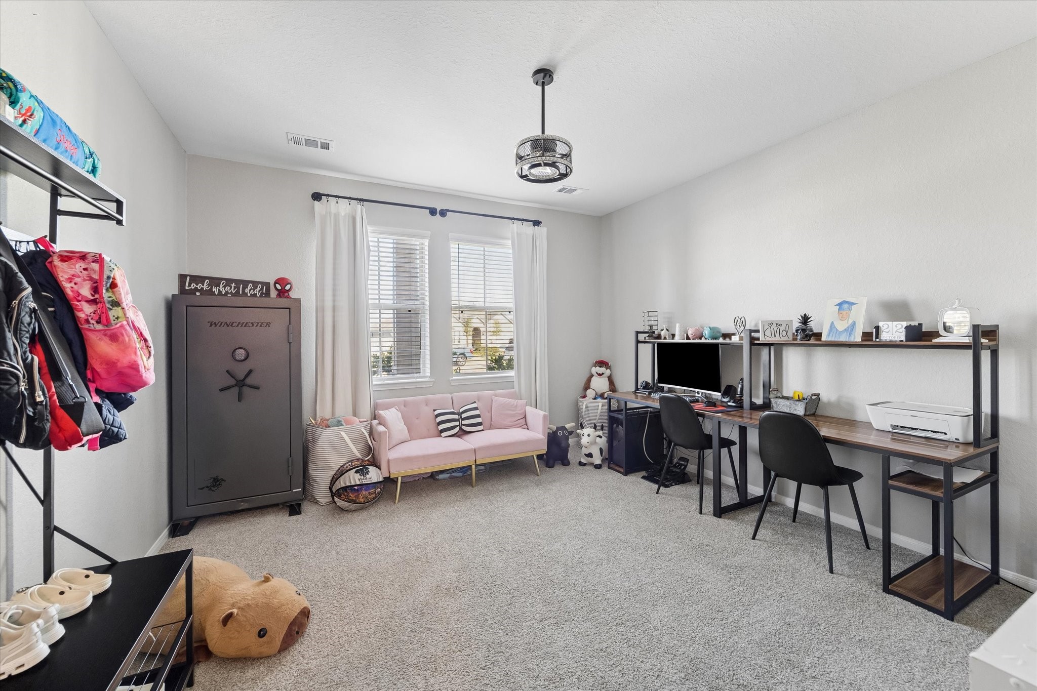An additional downstairs living space offers a comfortable retreat within the private guest wing. Paired with a bedroom and full bathroom, this area provides flexibility for extended stays or a potential mother-in-law suite.