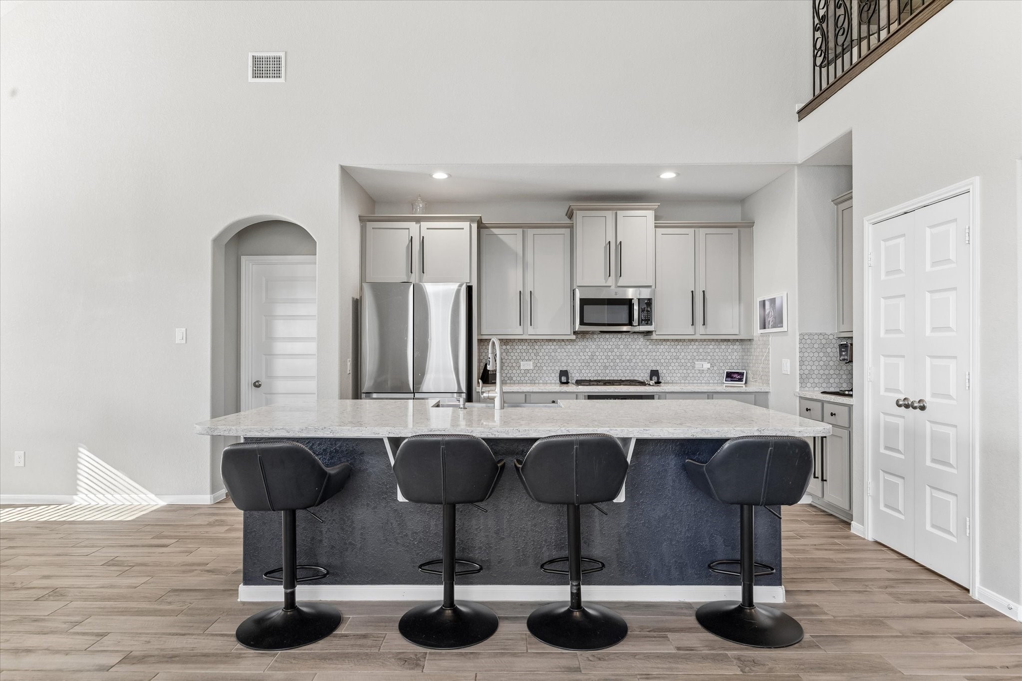 An expansive island provides room for meal preparation and casual seating, with open sightlines that keep everyone part of the conversation.