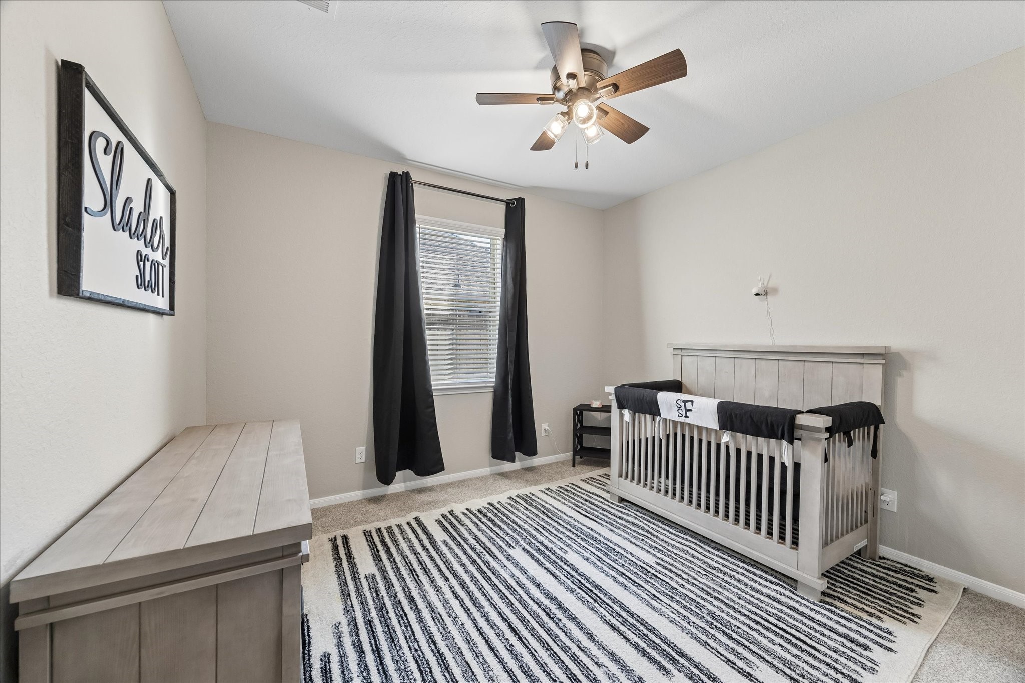 Located in the private downstairs guest wing, this bedroom connects with an additional living space and full bathroom, offering a flexible layout for guests or extended stays.