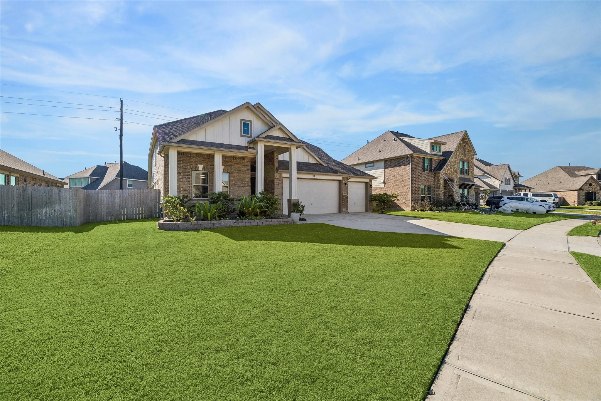 Set on a 9,766-square-foot lot in Lakes of Champions Estates, the home offers an expansive front lawn, refreshed Bermuda grass, and a sidewalk-lined streetscape.