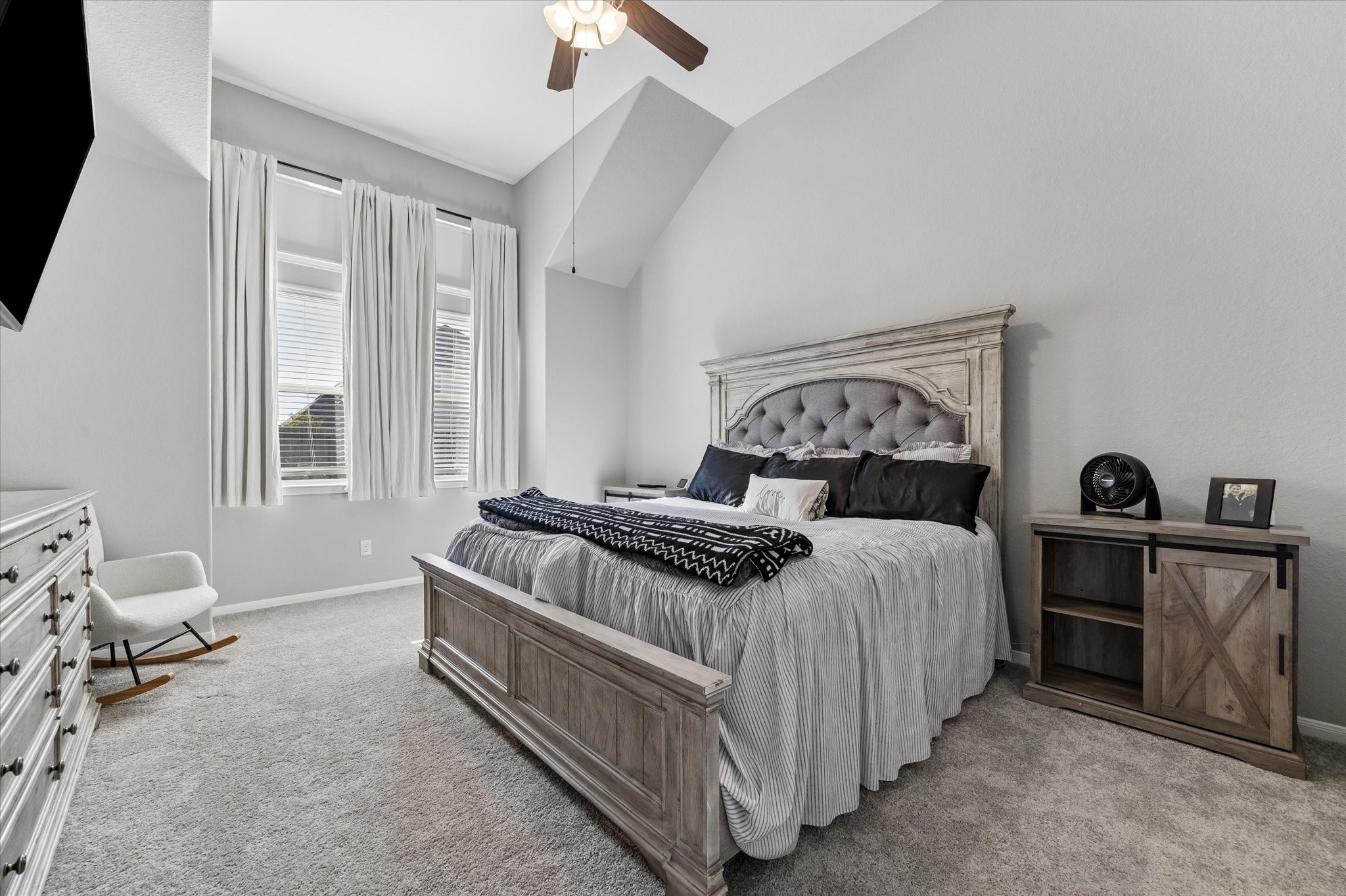 The first-floor primary bedroom offers a peaceful retreat with high ceilings, natural light, and new carpet installed in 2026. Its adjoining bathroom features a soaking tub, separate shower, and dual-sink vanity.