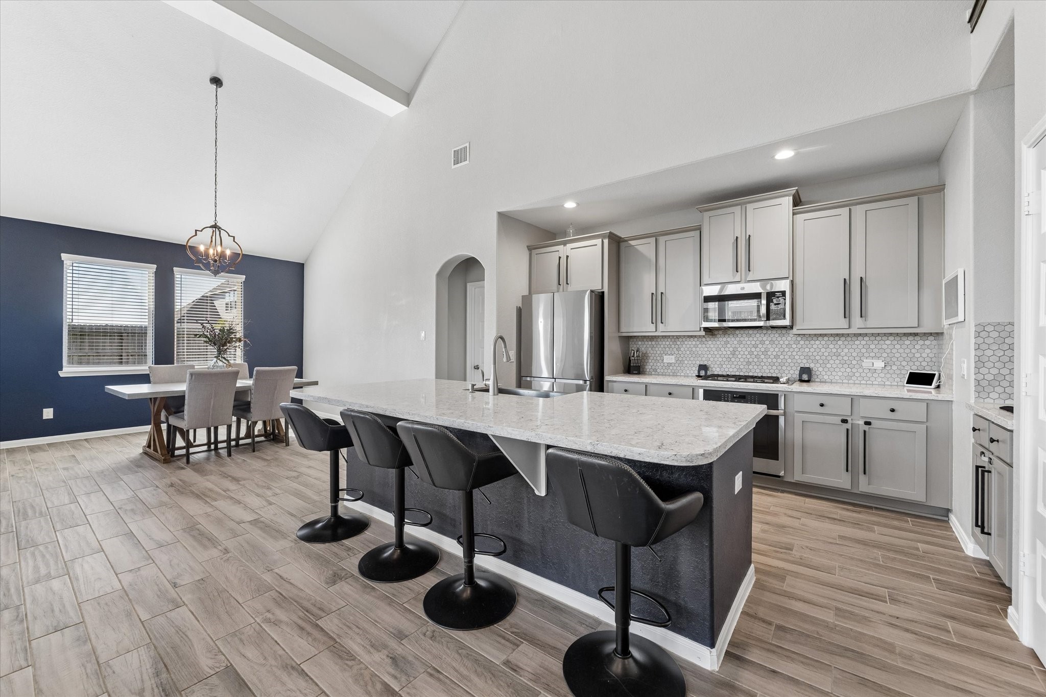 The adjoining dining area keeps meals close at hand, while the island offers additional seating for quick breakfasts and easy conversation.