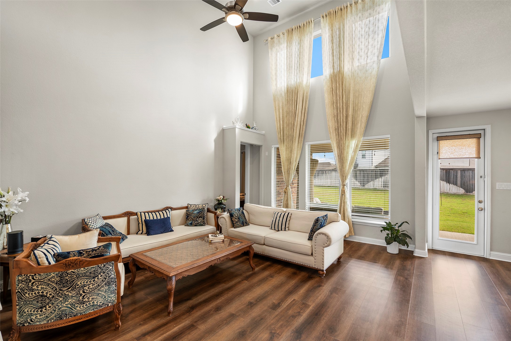 Another view of the living room showcasing the impressive windows and open feel.