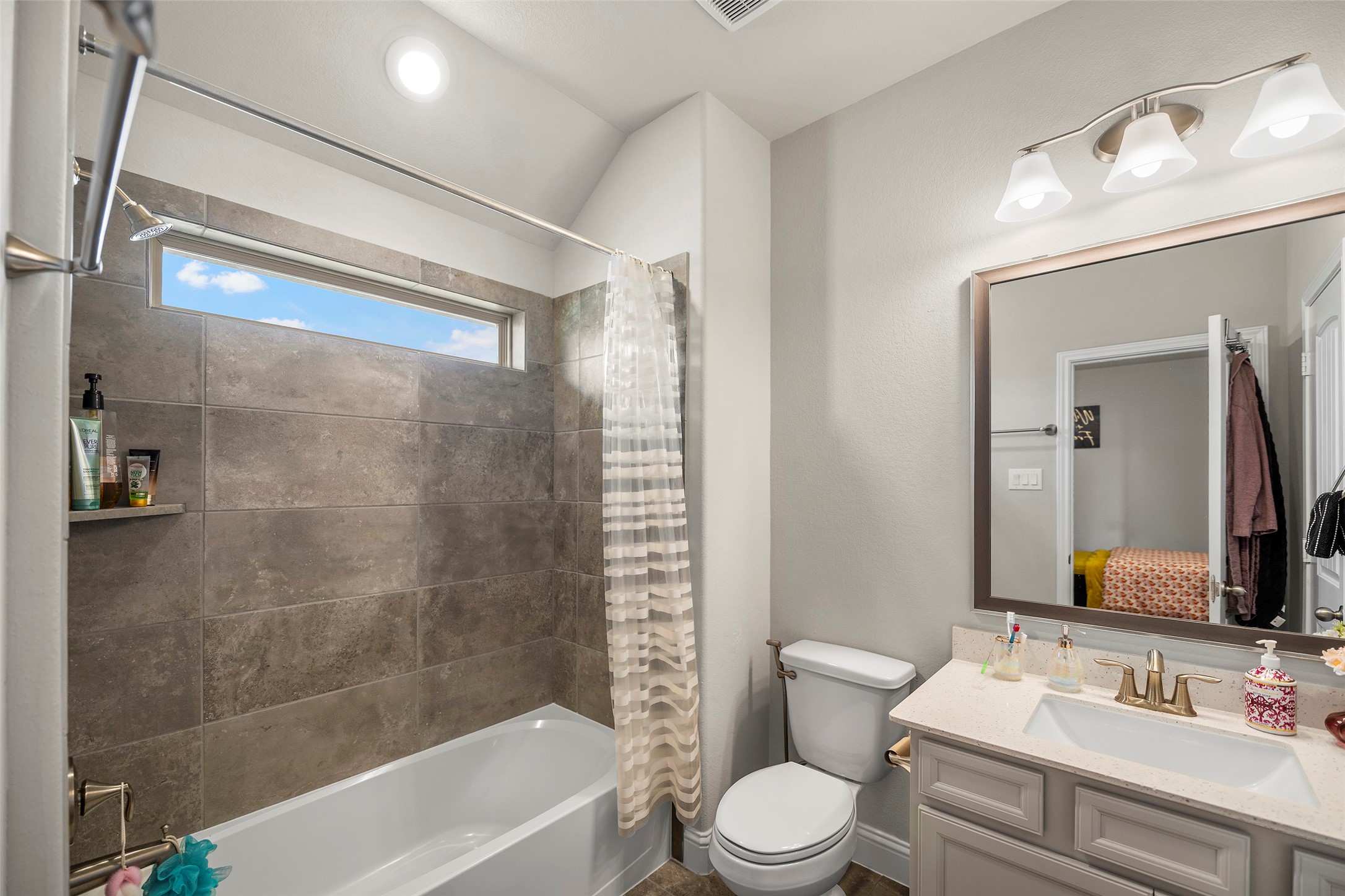 Another view of the full bathroom with a tub and shower combination.