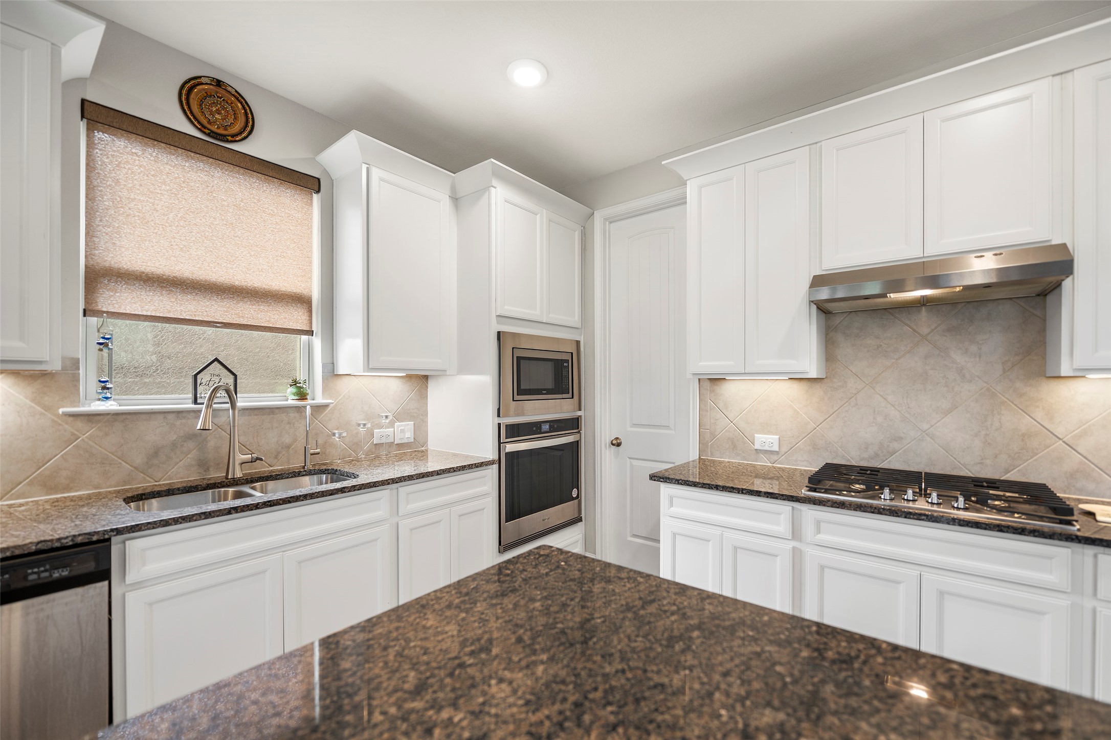 Another kitchen view highlighting the ample cabinetry and counter space.
