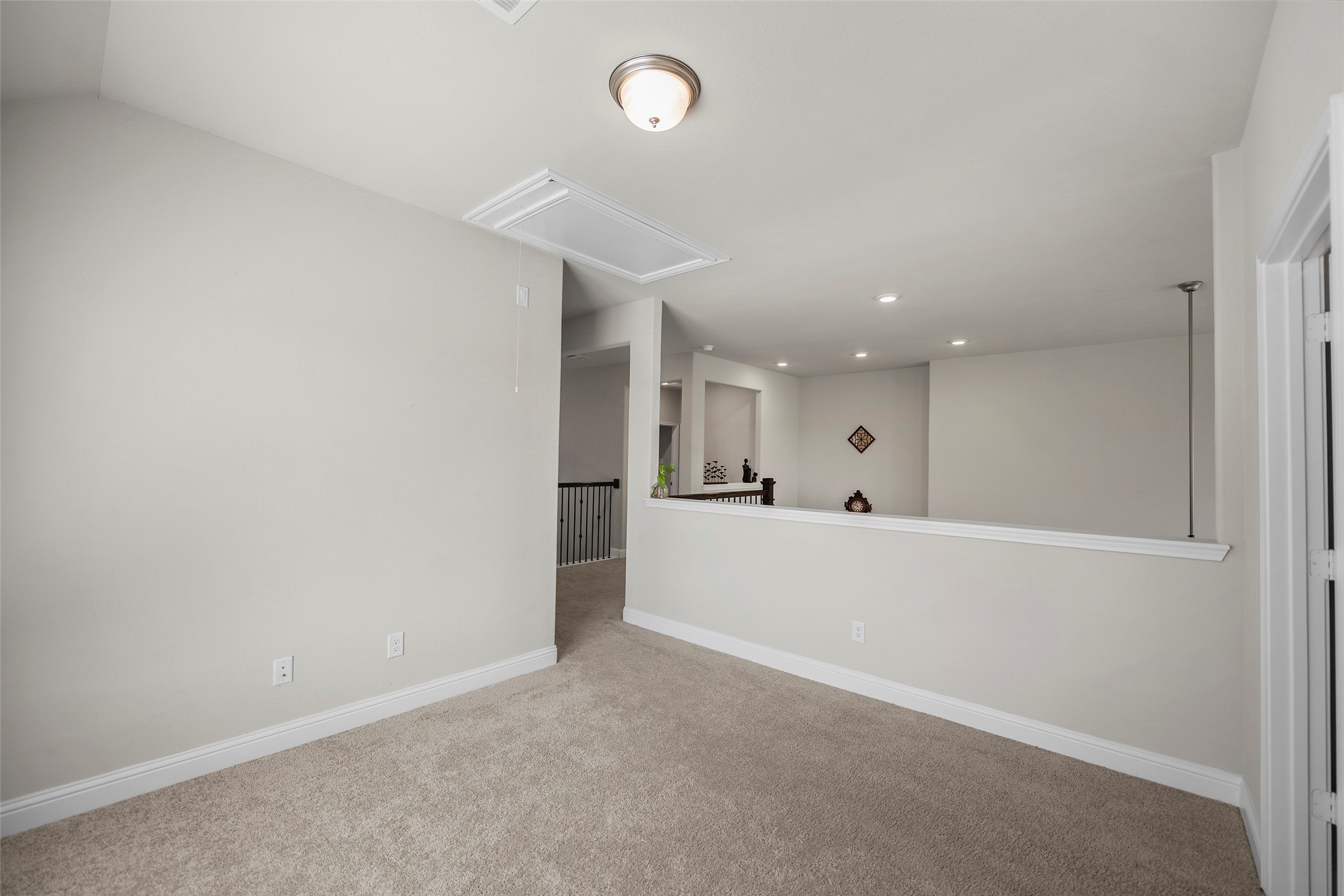 Upstairs game room offering flexible space for relaxing or entertaining.