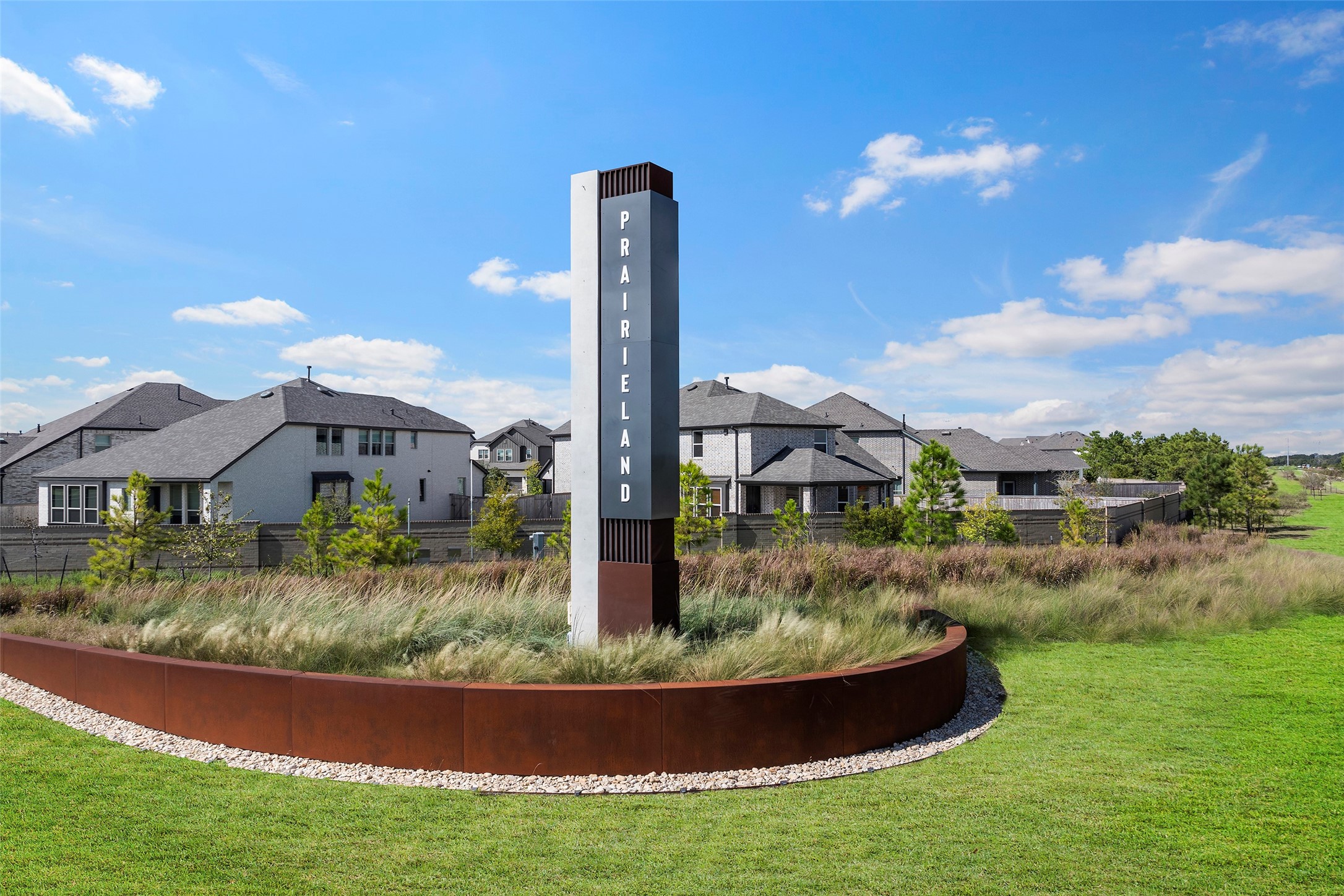 Welcoming community entrance surrounded by attractive landscaping.