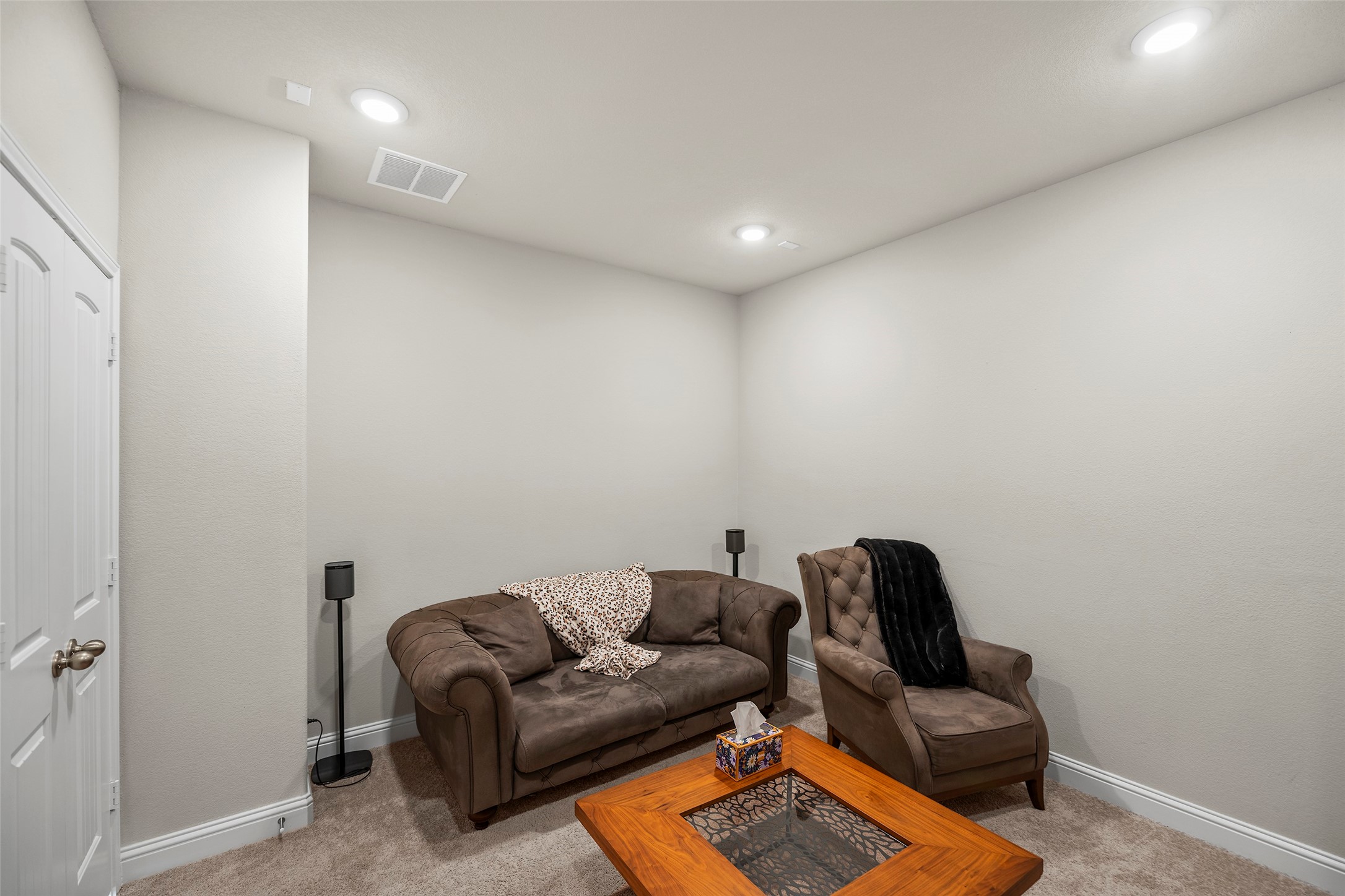Versatile upstairs media room ideal for movie nights or additional gathering space.