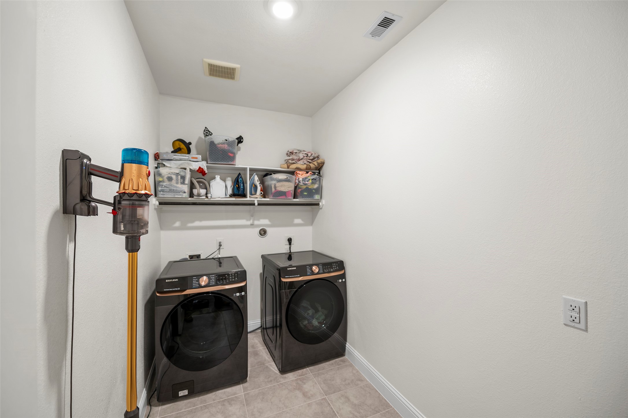 Convenient laundry room with space for everyday household needs.