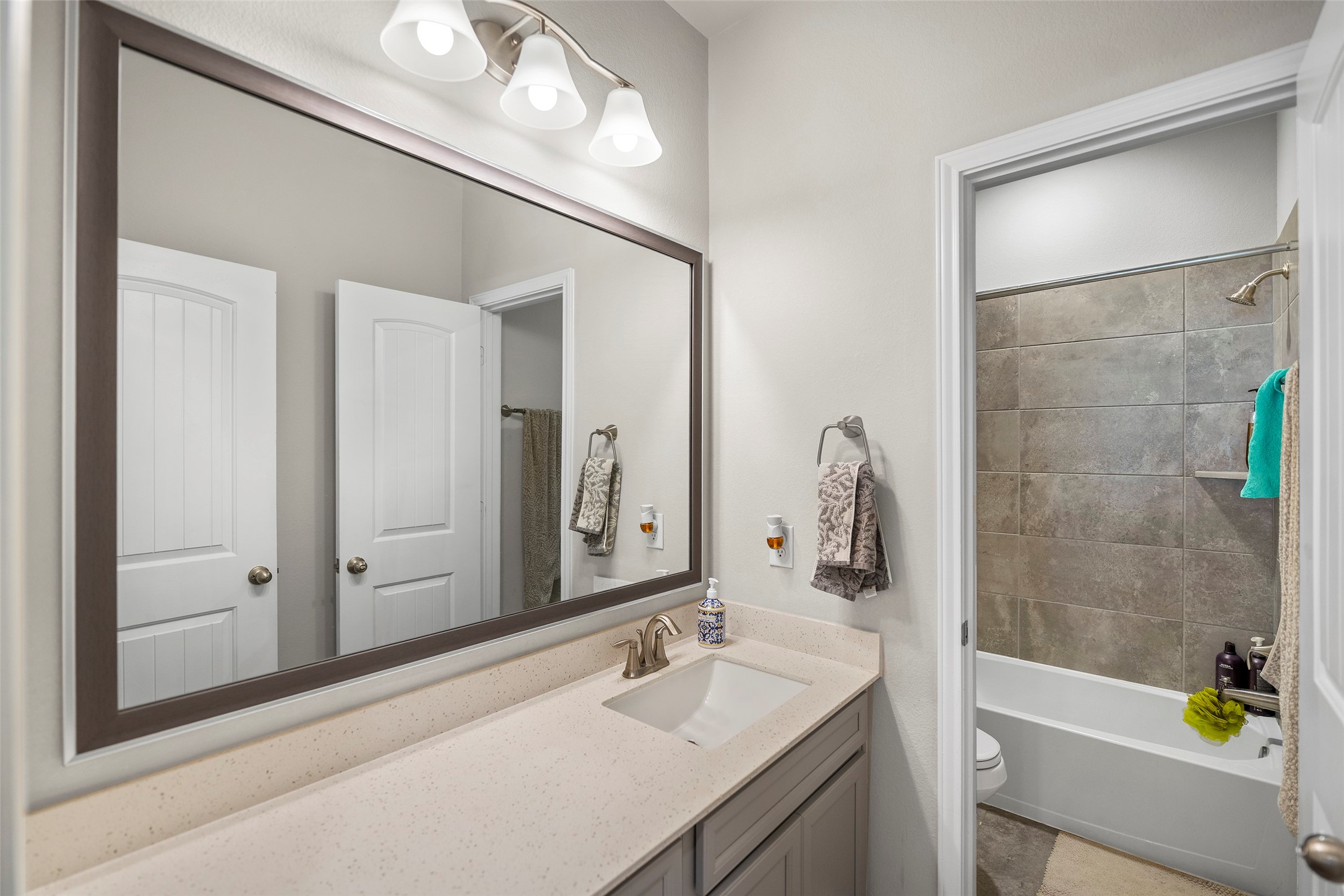 Full bathroom with a generous vanity and clean, bright finishes.