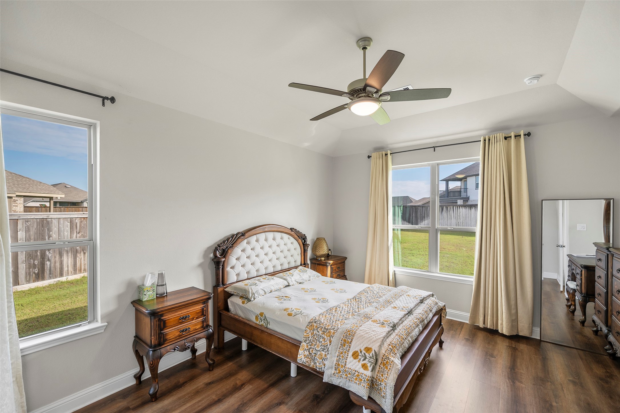Spacious primary bedroom with large windows and plenty of natural light.