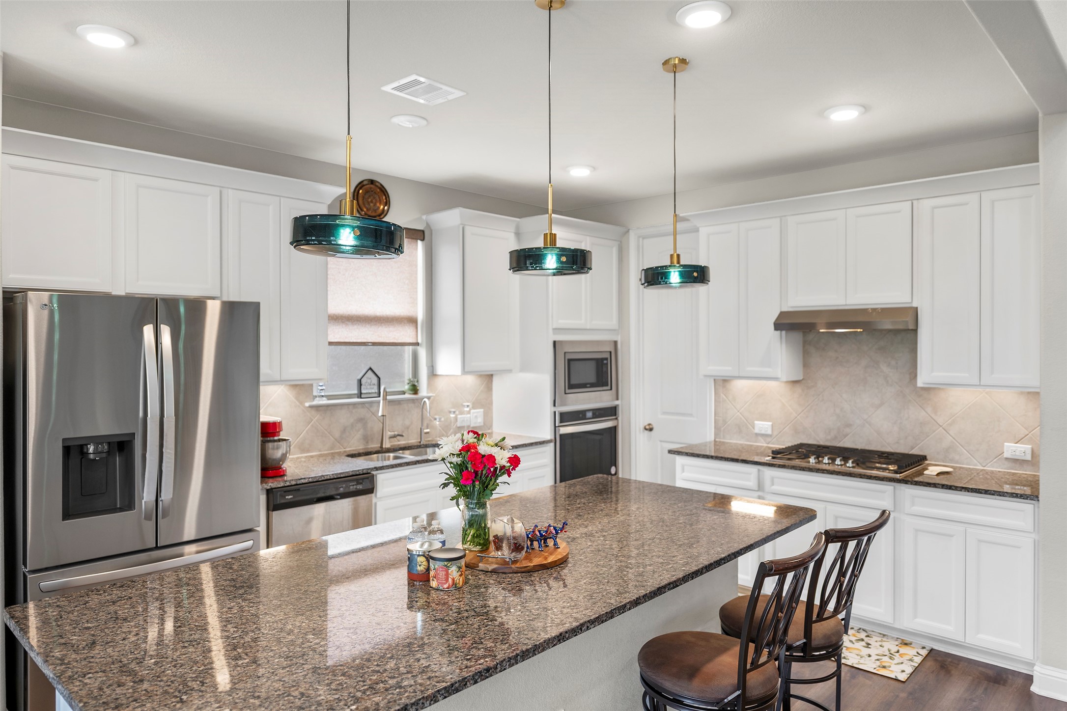 Spacious kitchen with a large center island, generous cabinetry, and plenty of workspace.