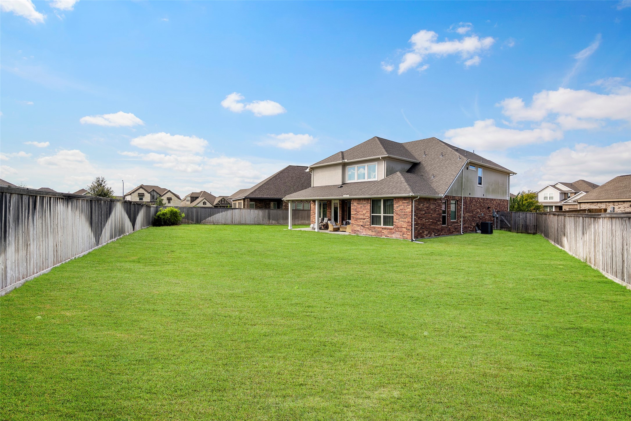 Expansive fenced backyard with plenty of open green space.