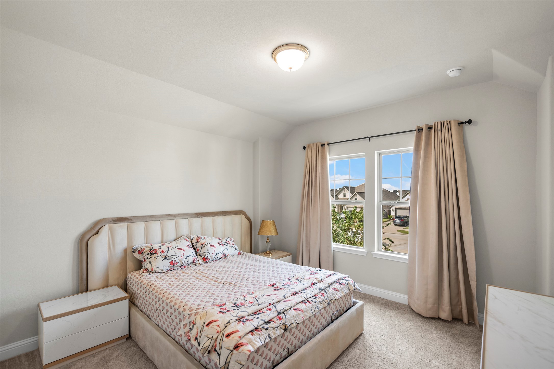Bright bedroom with a large window bringing in natural light.