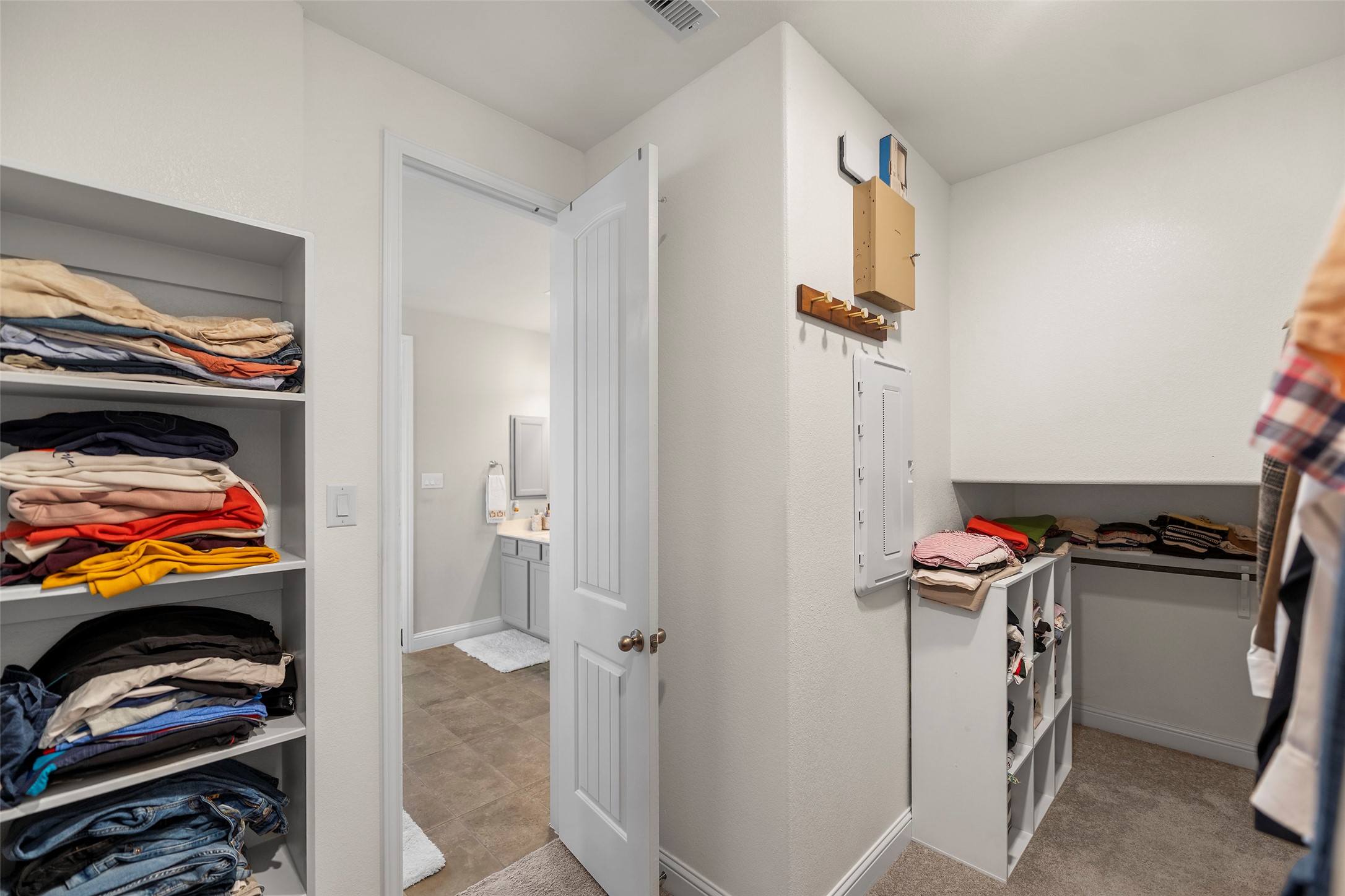 Walk-in closet offering generous shelving and storage space.