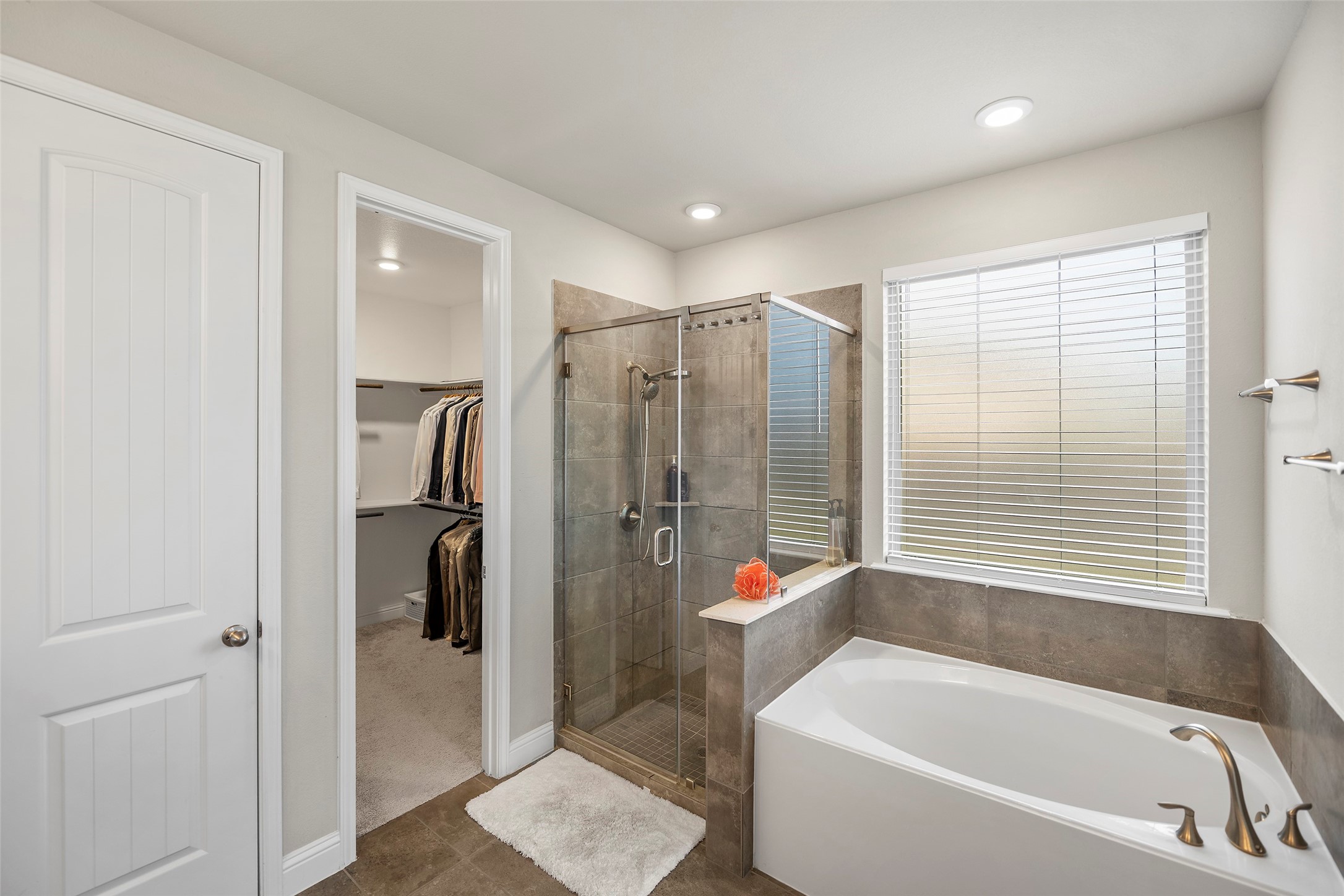 Primary bathroom with a soaking tub, separate shower, and spacious layout.