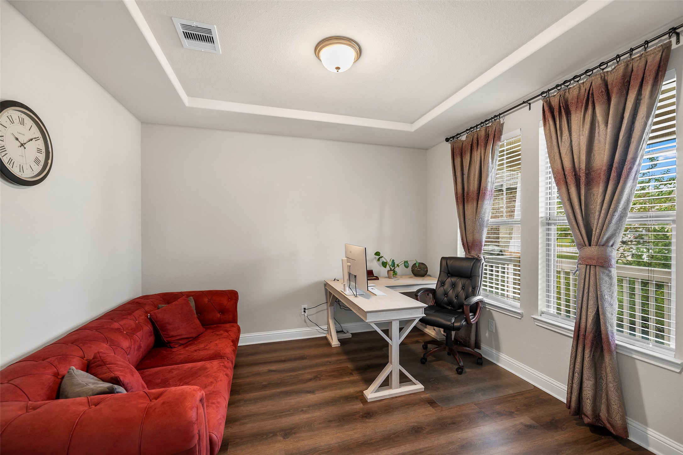 Versatile front room with natural light, ideal for a home office or sitting area.