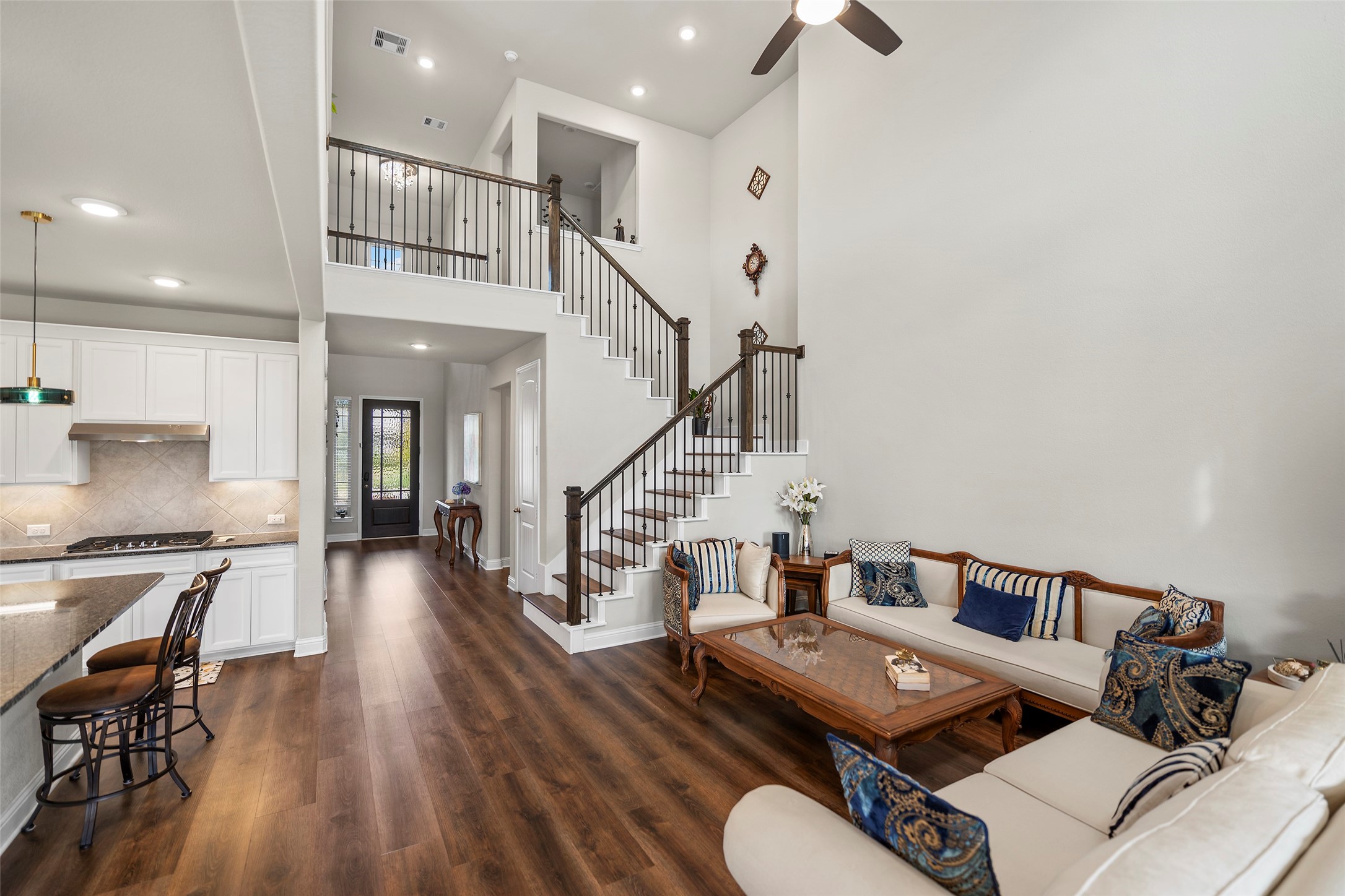 Another view of the living area highlighting the open layout and staircase.