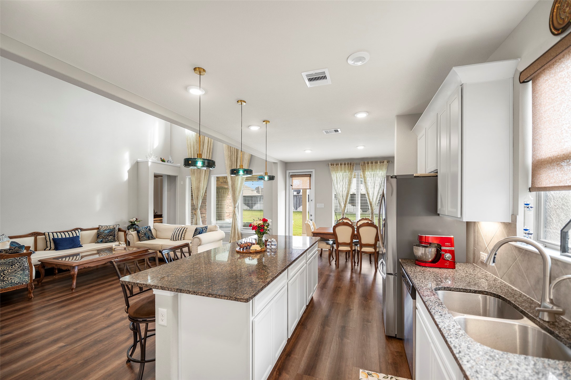 Open-concept layout offering an easy flow between the kitchen, dining, and living areas.
