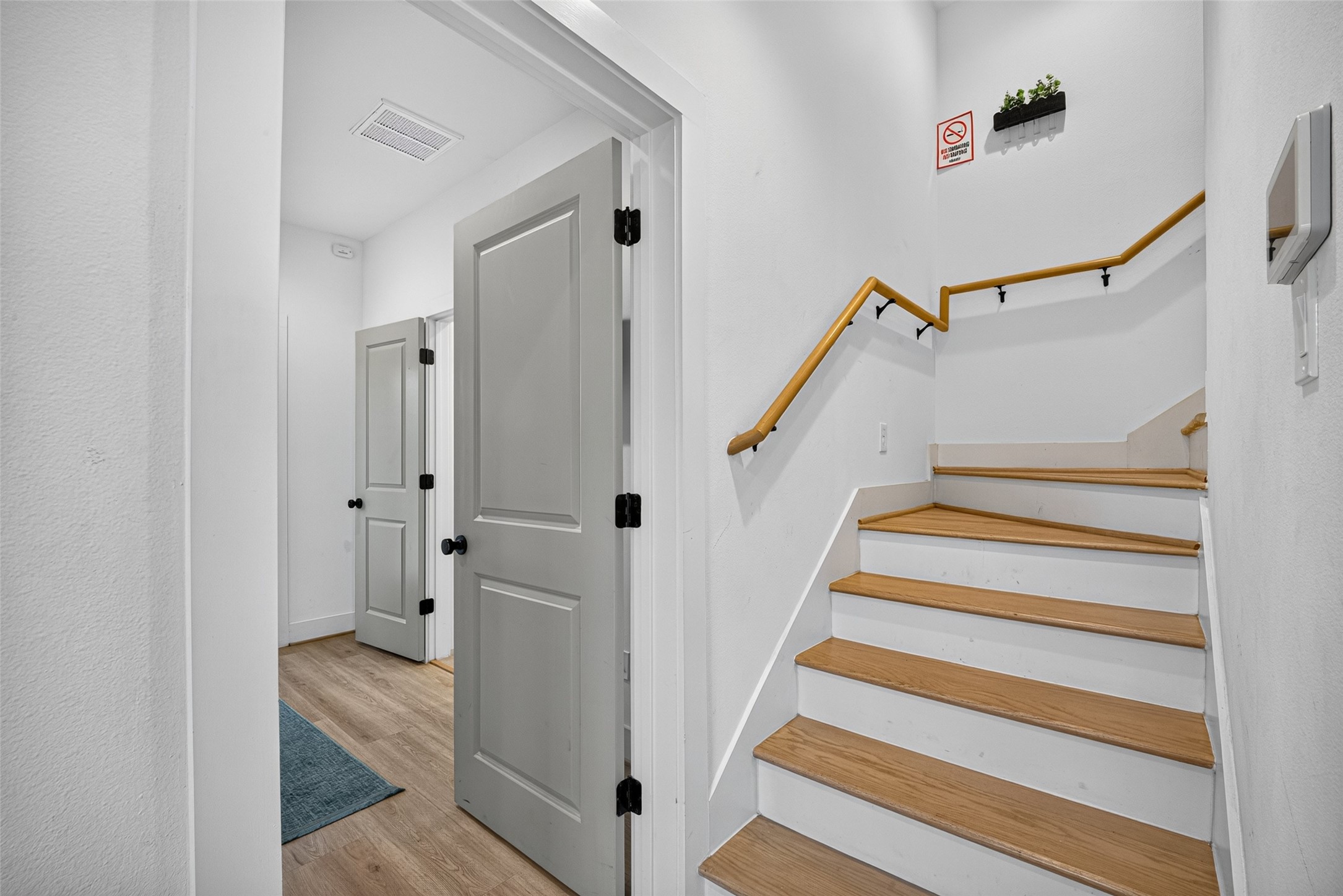 Inside the entry, rich wooden treads contrast against white risers, guiding the eye up a winding stairwell toward the upper levels. Inside the entry, rich wooden treads contrast against white risers, guiding the eye up a winding stairwell toward the upper levels.