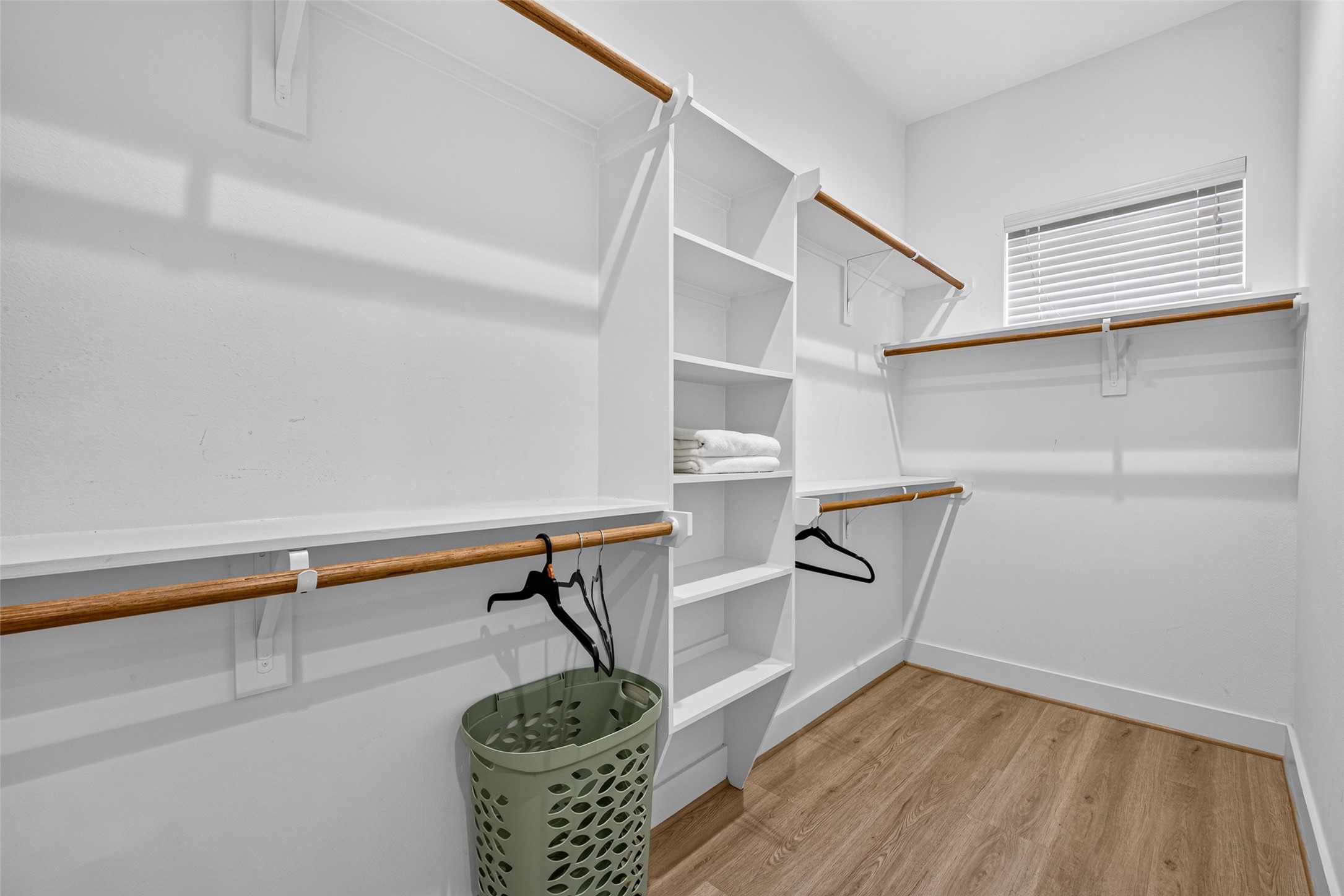 Maximized organization awaits inside this large full-entry closet, fully outfitted with custom hanging rods and multi-tier shelving.