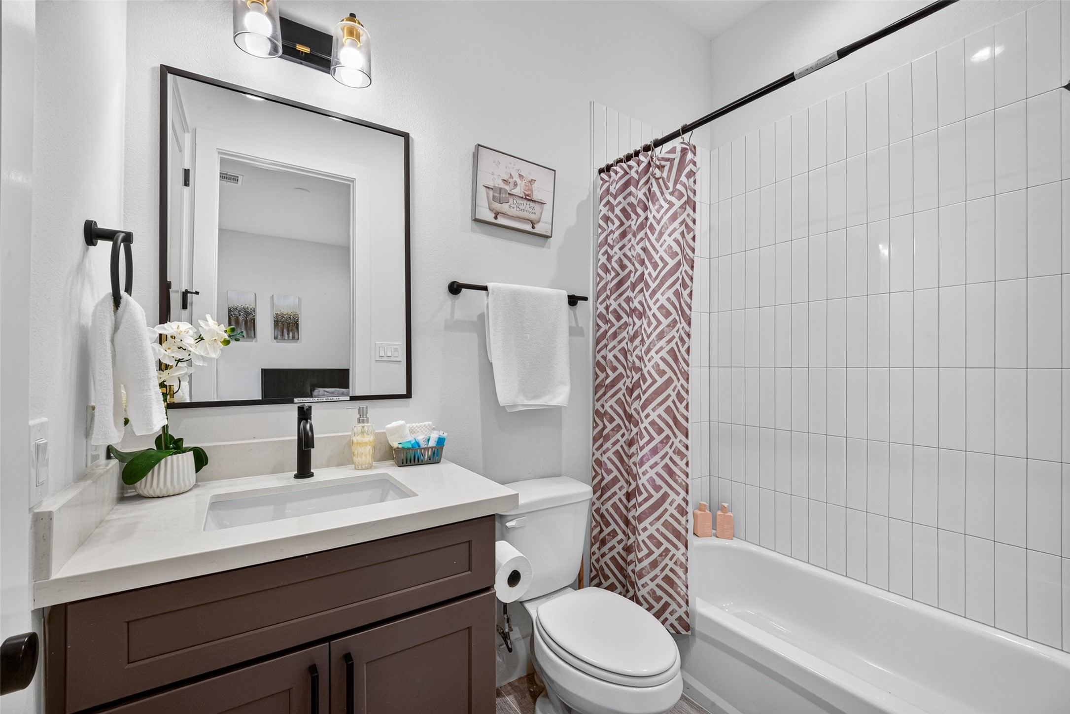 A vanity and shower-tub combination wrapped in tile give this private bath a fresh, contemporary finish consistent with the home's overall design.