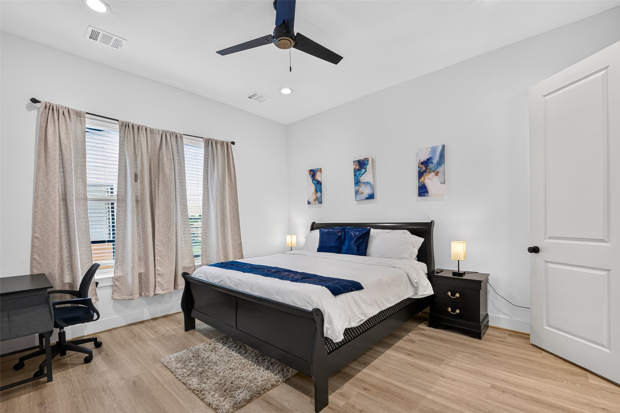 Generous proportions, large windows, and a ceiling fan give the primary bedroom a comfortable, airy feel, with direct access to the en-suite bath and a spacious full-entry closet.